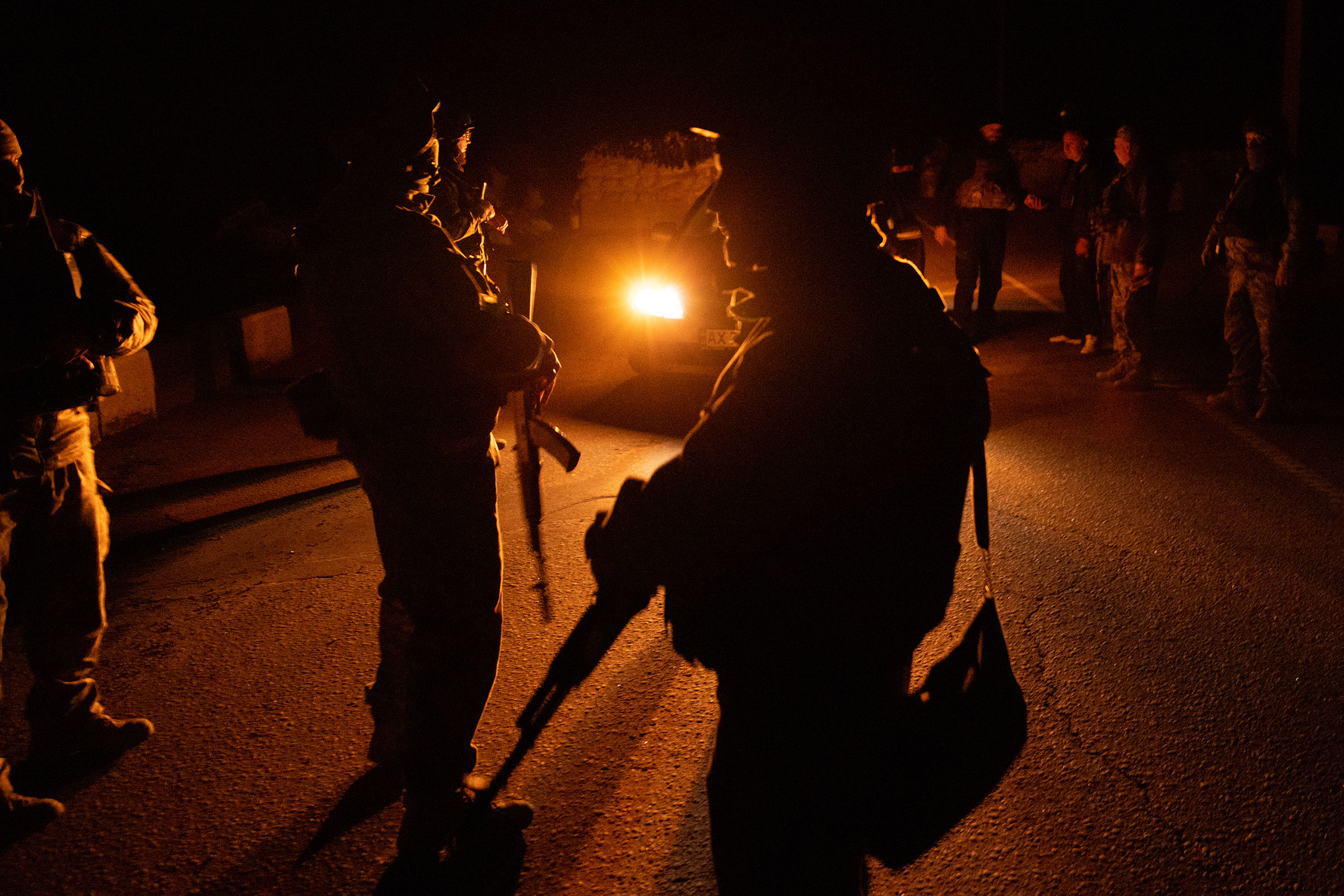 Members of the Territorial Defense Force brigade search vehicles after curfew on a road on the outskirts of Kharkiv on April 4, 2022 in Kharkiv, Ukraine. 