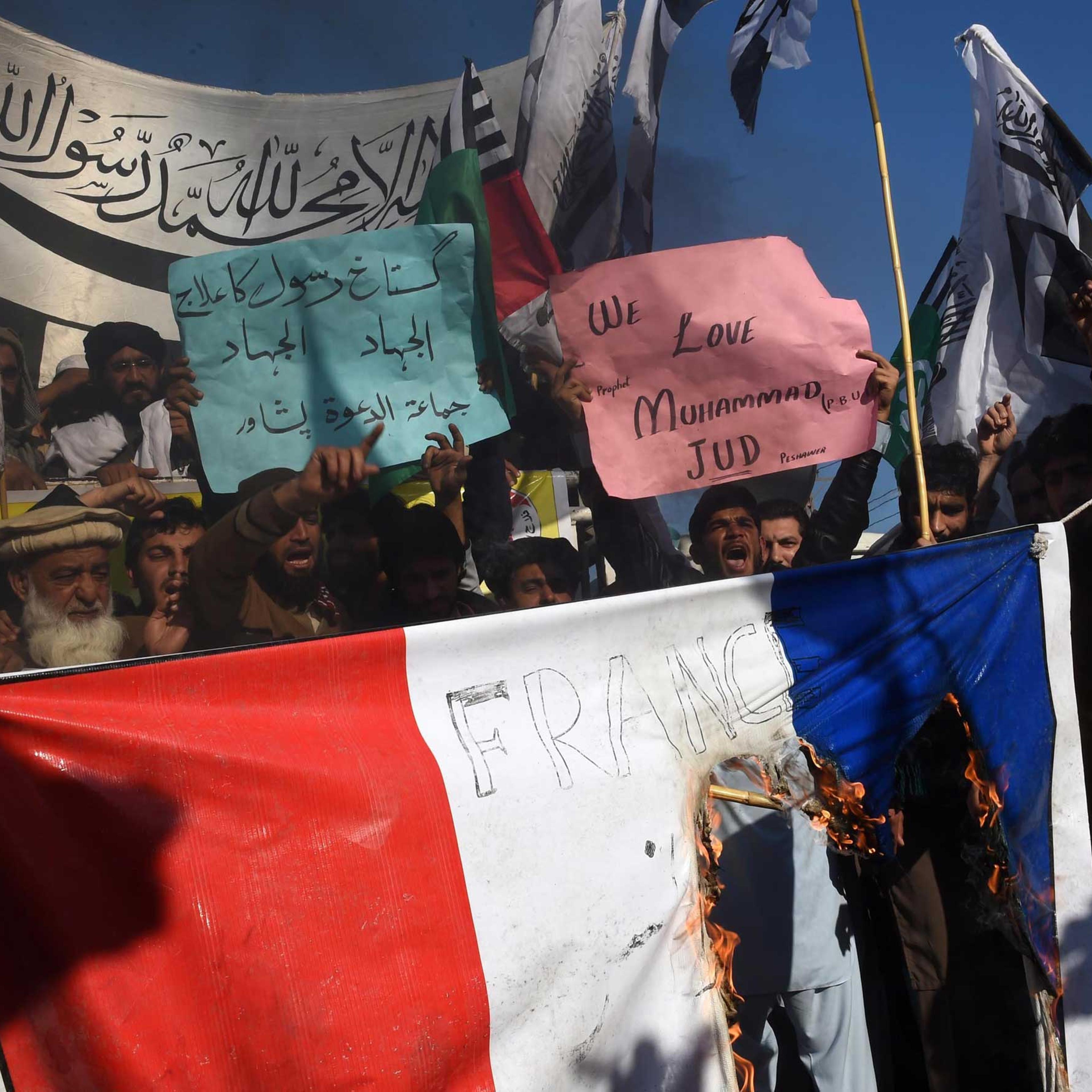 Pakistani protesters burn a French flag during a protest against the printing of satirical sketches of the Prophet Muhammad by French magazine Charlie Hebdo in Peshawar, Pakistan on Jan. 16, 2015.