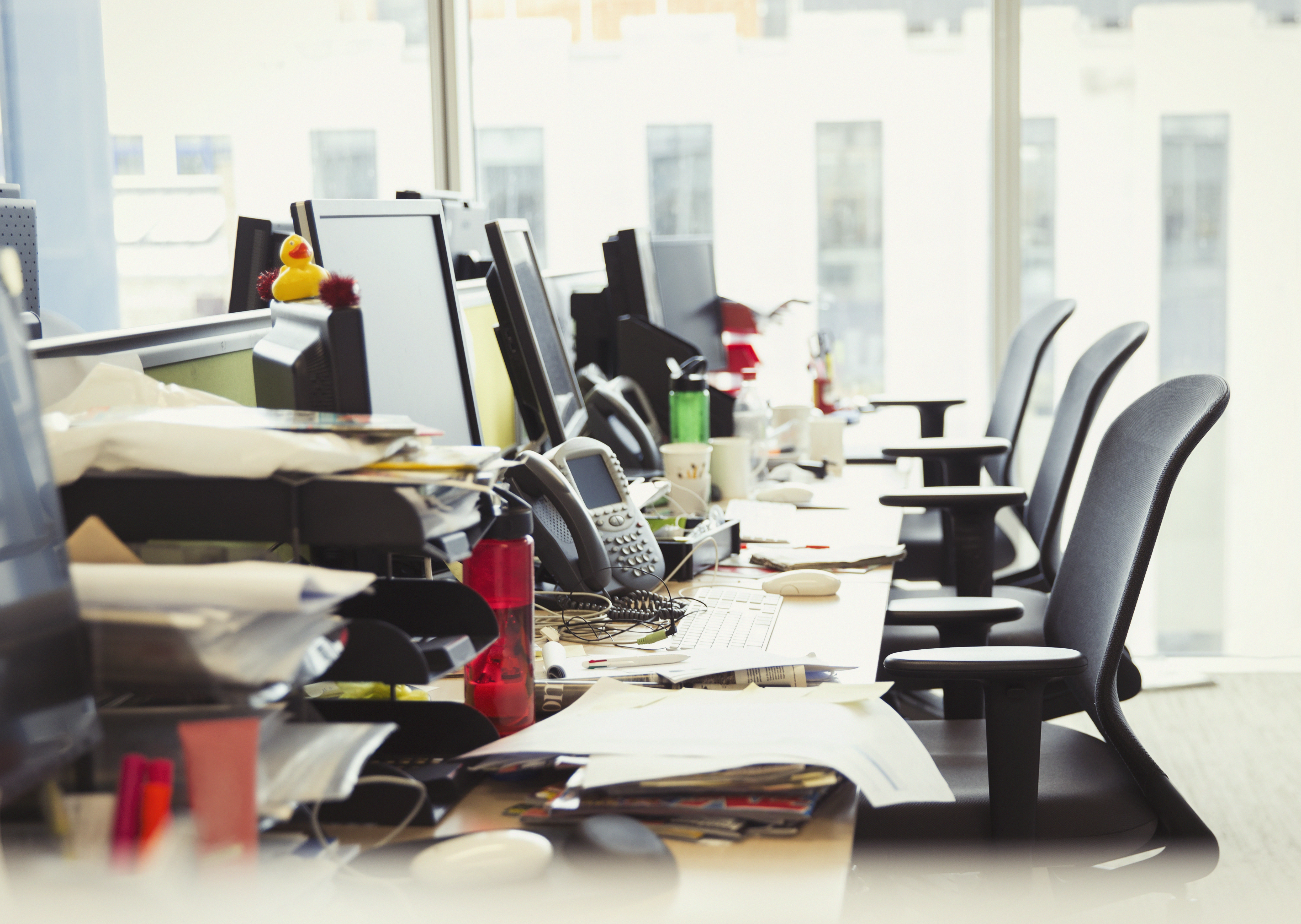 Messy row of desks in office