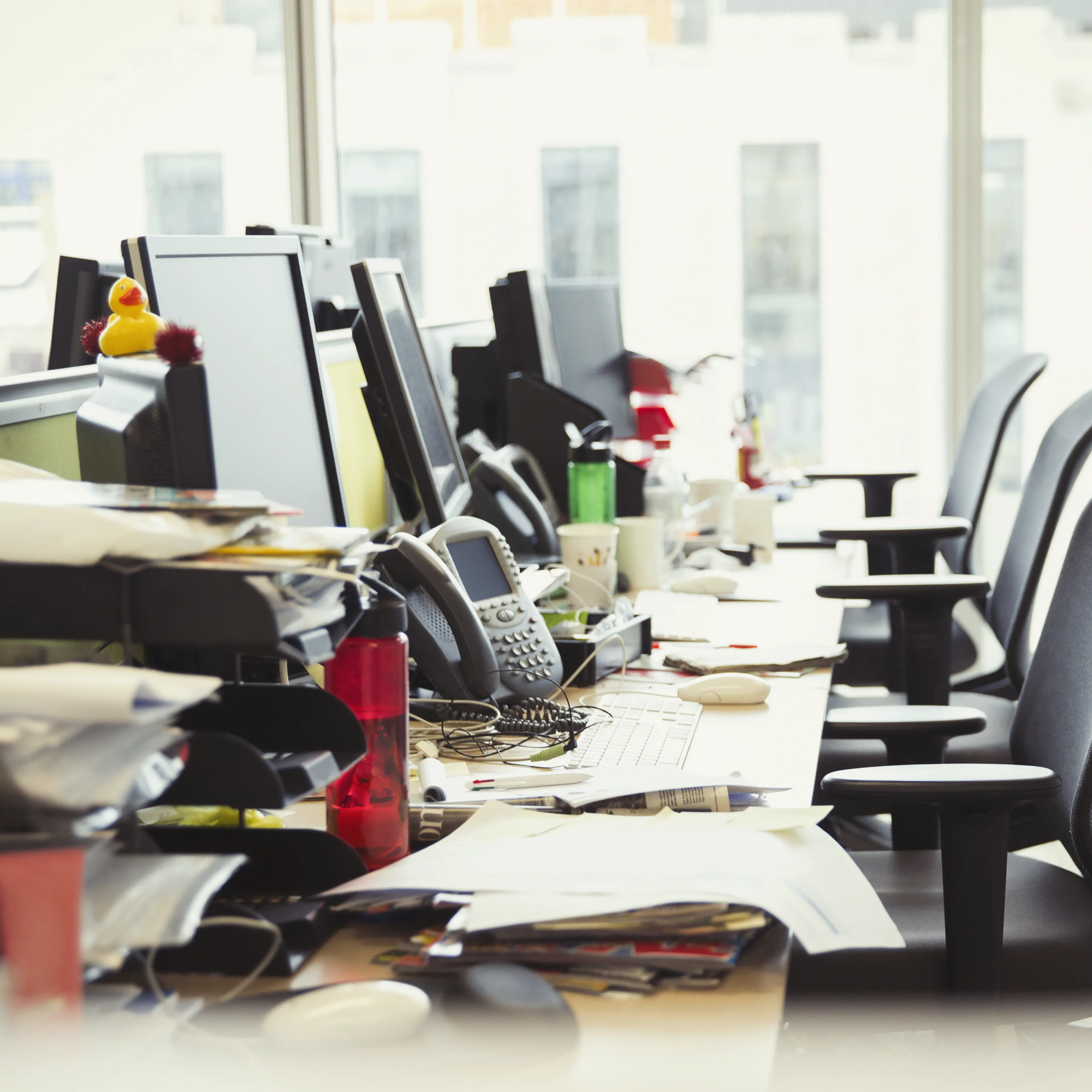 Messy row of desks in office