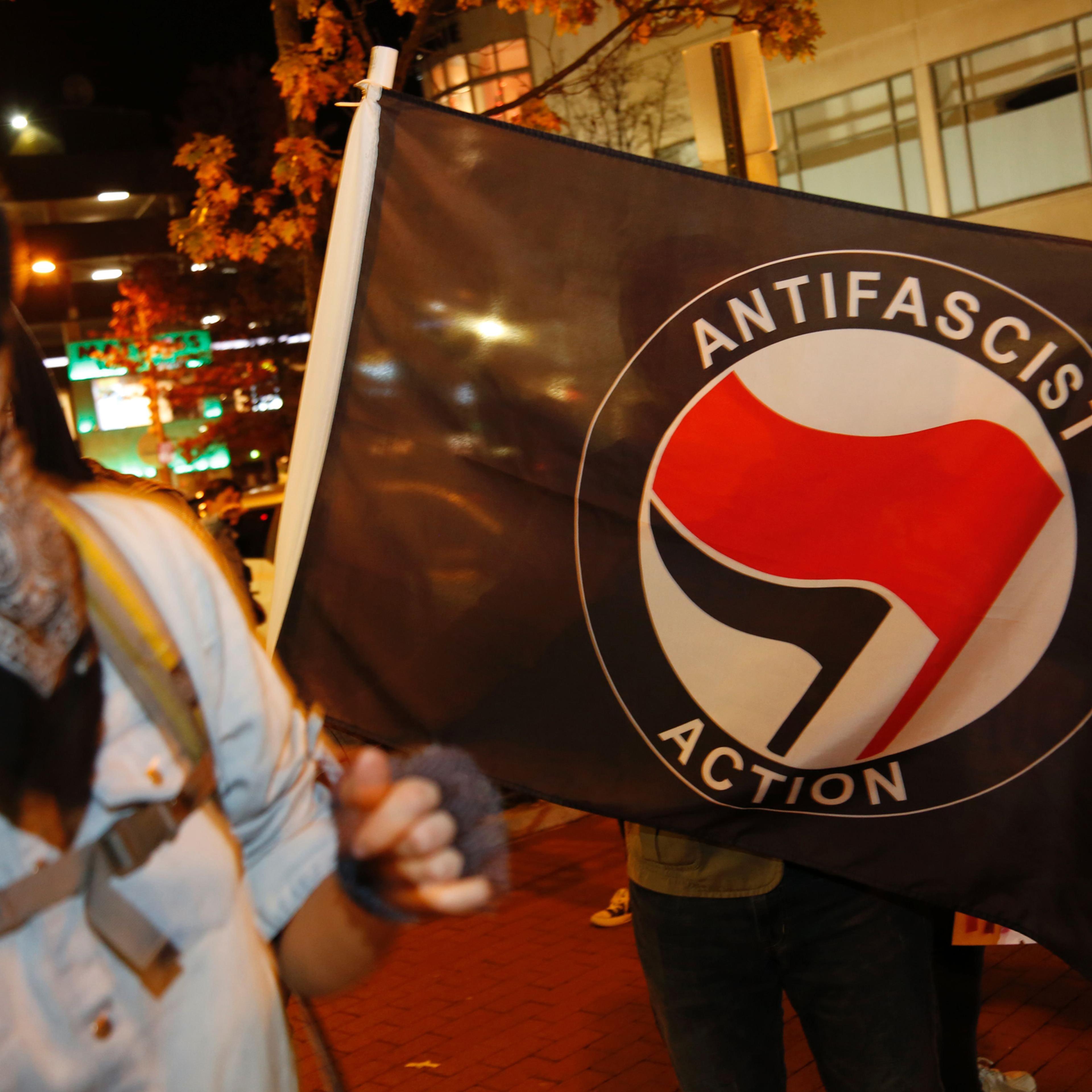 Members of DC Antifascist Coalition protest in opposition to a conference by the National Policy Institute in front of the Magliano's restaurant in Washington, DC on November 18, 2016. / AFP PHOTO / Andrew BirajANDREW BIRAJ/AFP/Getty Images