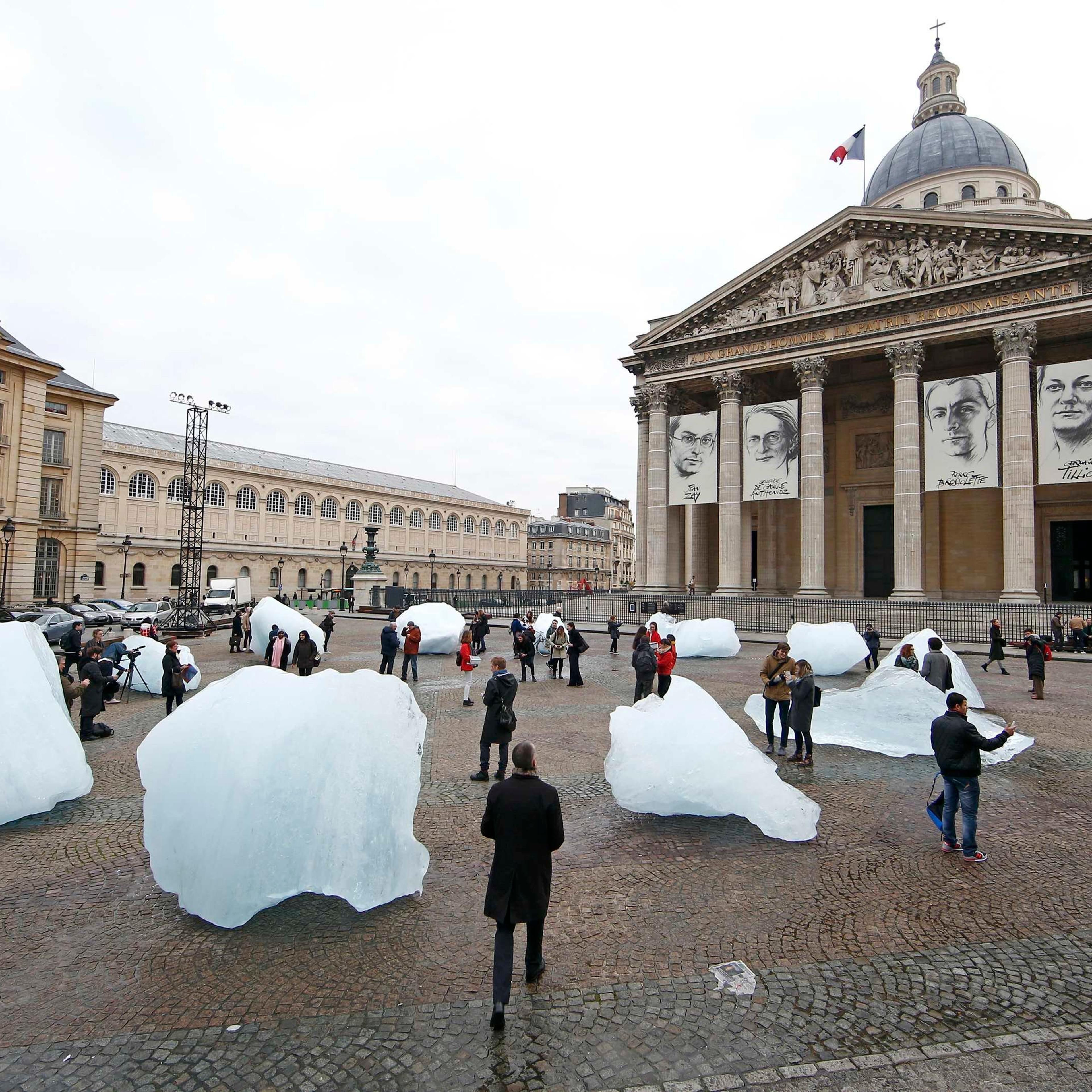Visitors walk through ice blocks from Greenland installed on the Place du Pantheon for a project called Ice Watch Paris