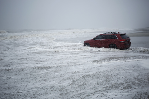 A Jeep Grand Cherokee sits stranded on a beach during Hurricane Dorian in Myrtle Beach, South Carolina, on Thursday, Sept. 5, 2019.