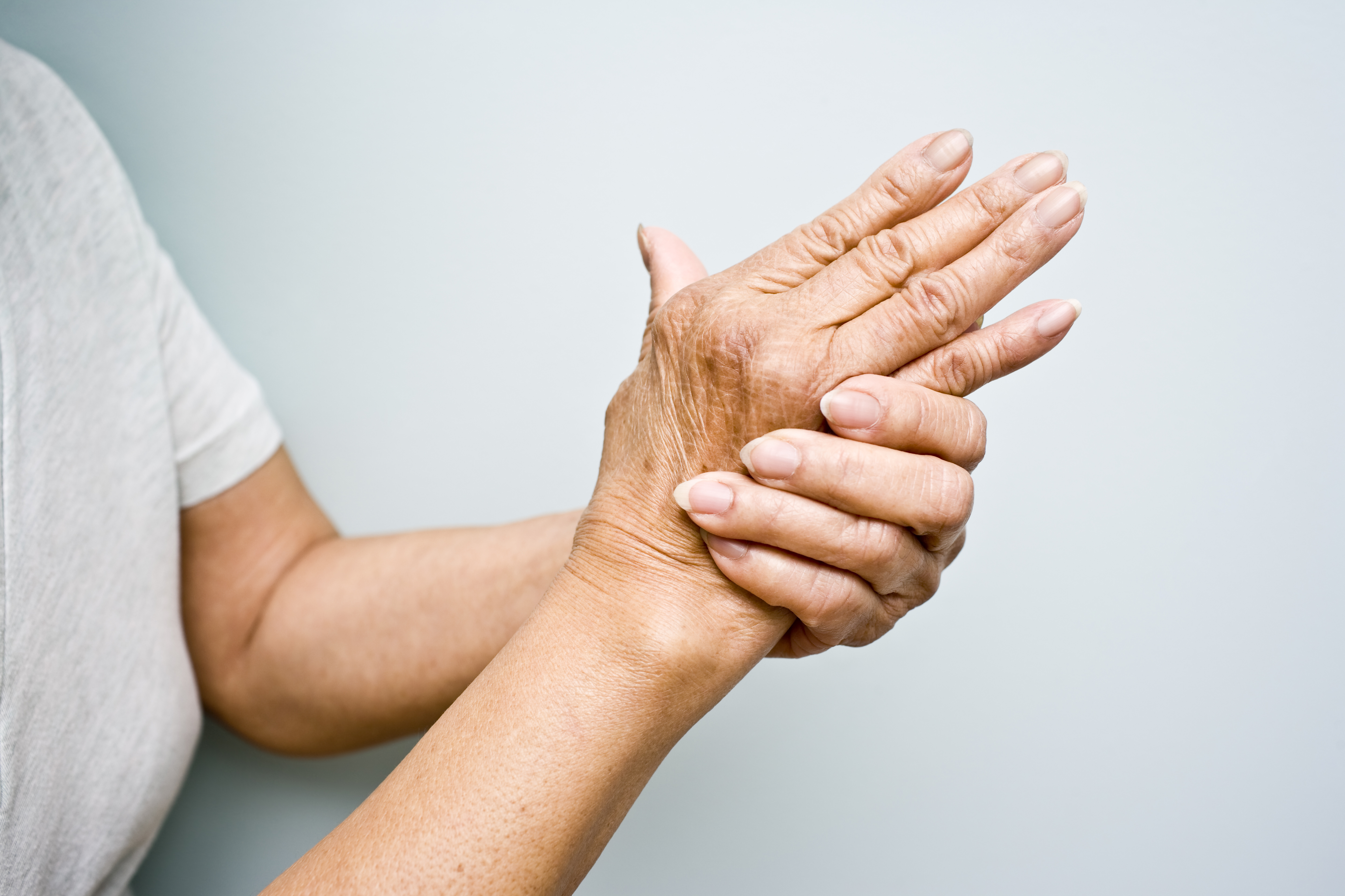 Elderly woman with Arthritis in her hands TIME health stock