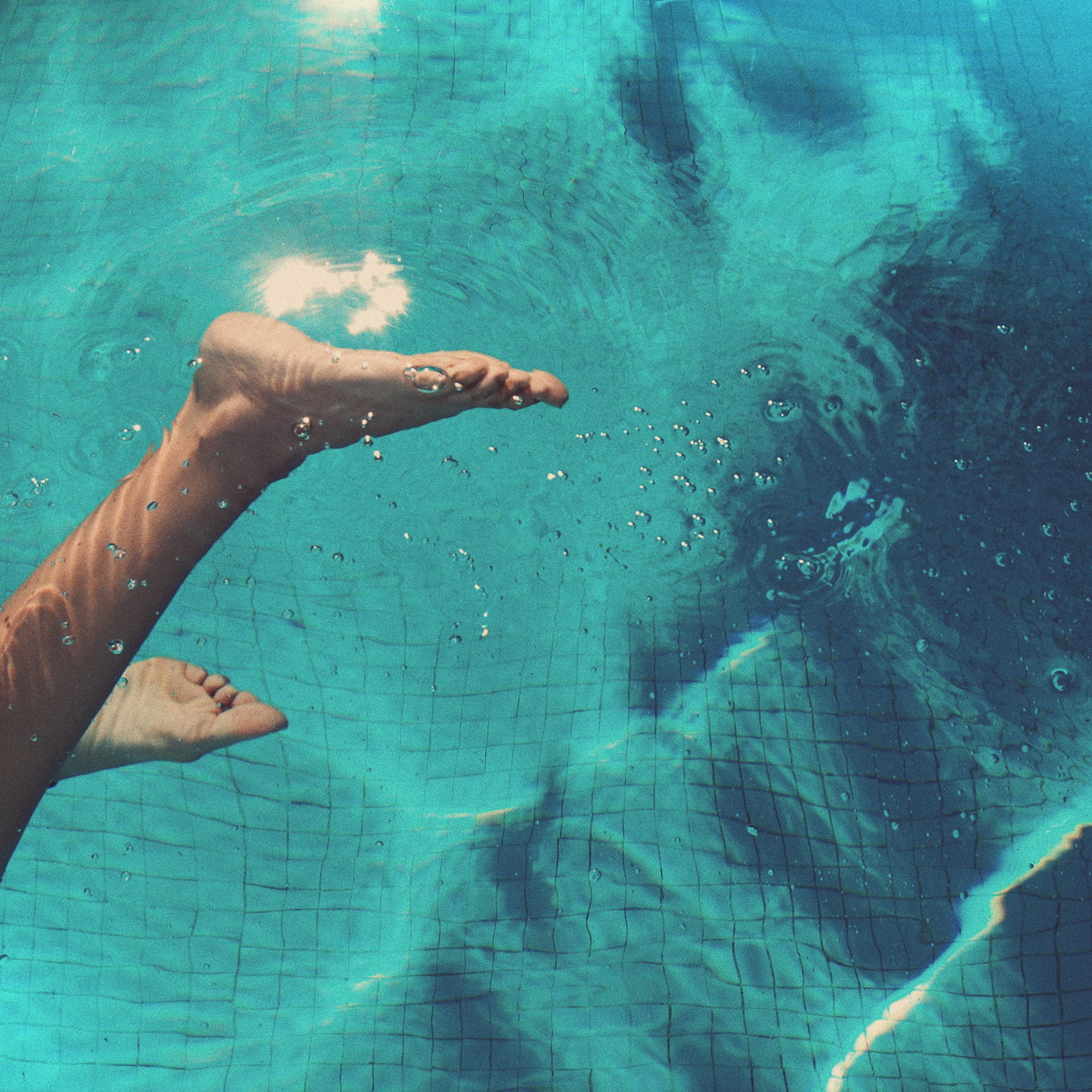 Low Section Of Woman Swimming In Pool