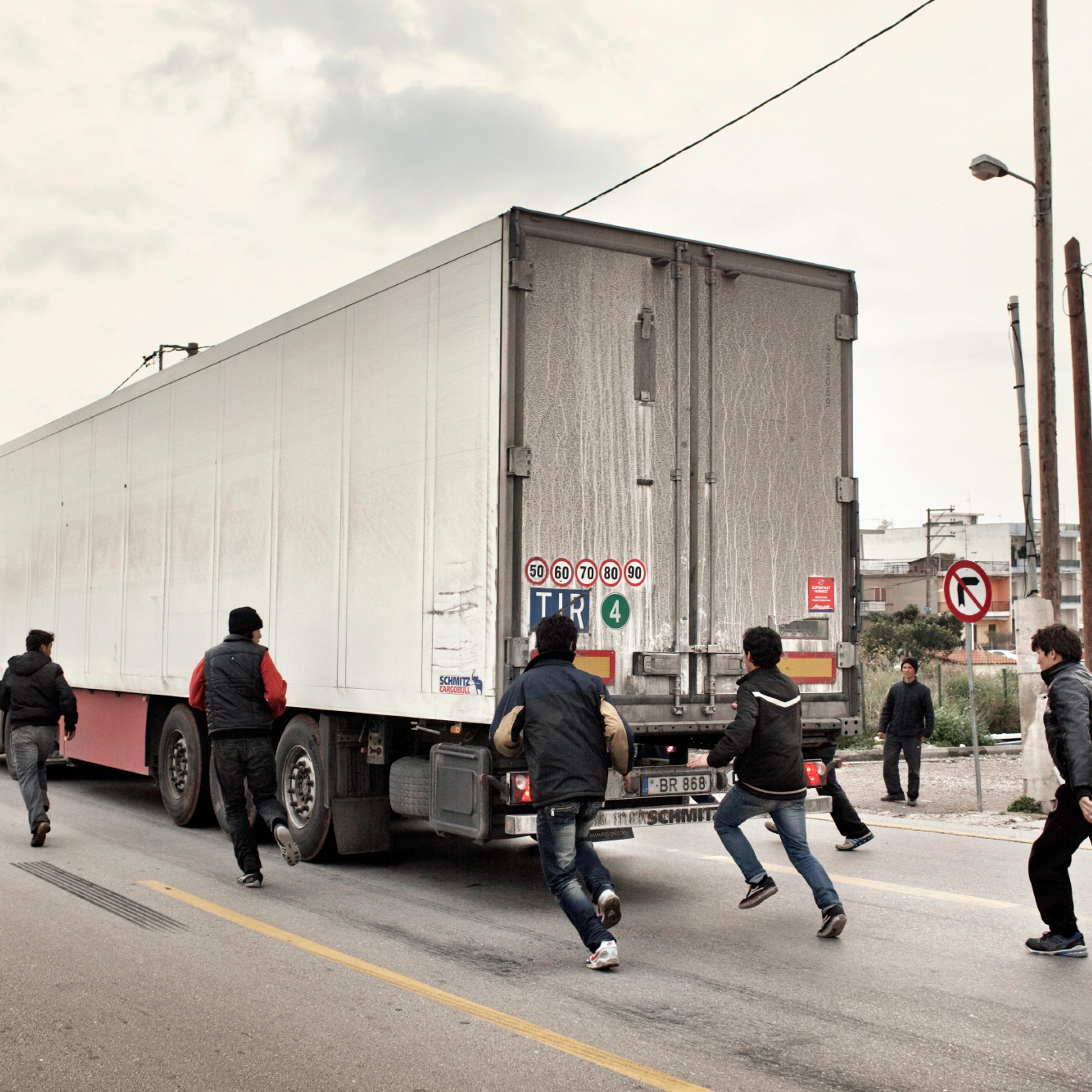 2012. Patras. Greece. A group of adolescents trying to illegally board trucks going to Italy.A group of Afghan boys aged 14 to 18 years, on a traffic island. Every day, these kids try to illegally board trucks going towards Italy. One of the most common