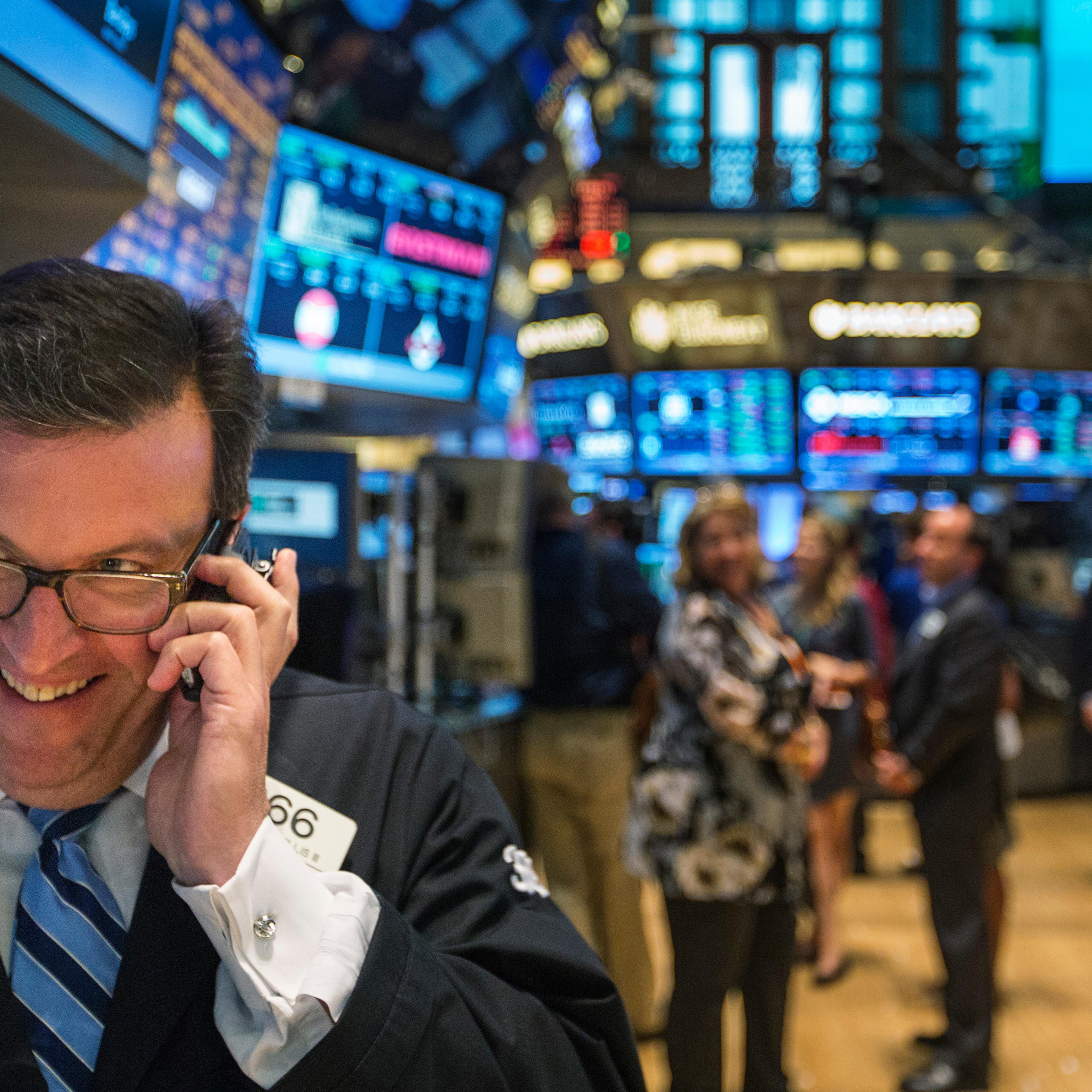A trader works on the floor of the New York Stock Exchange shortly before the end of the day's trading in New York July 31, 2013
