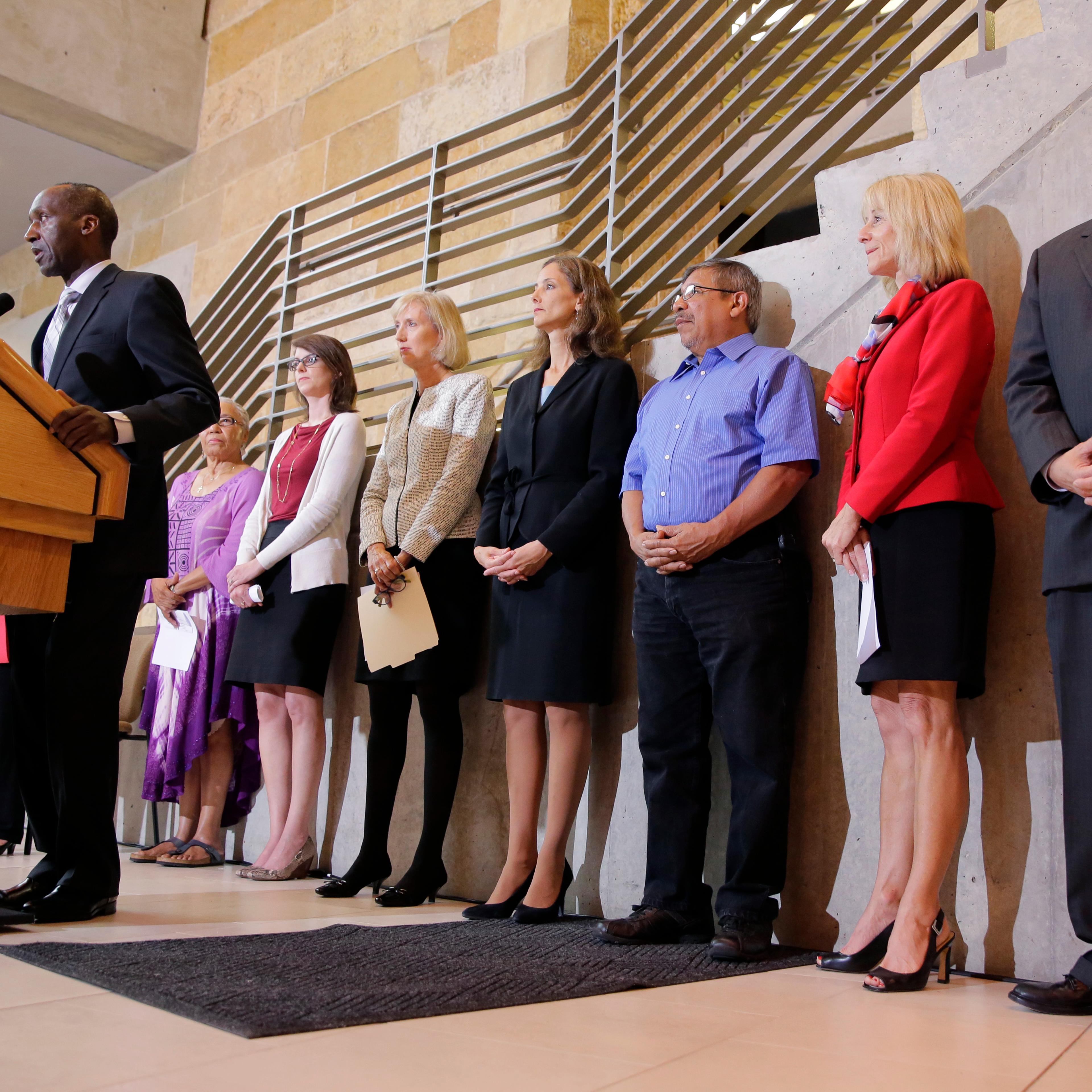 Members of the Austin city council listen to city manager Marc Ott during a news conference at City Hall, on May 13, 2015, in Austin, Texas.