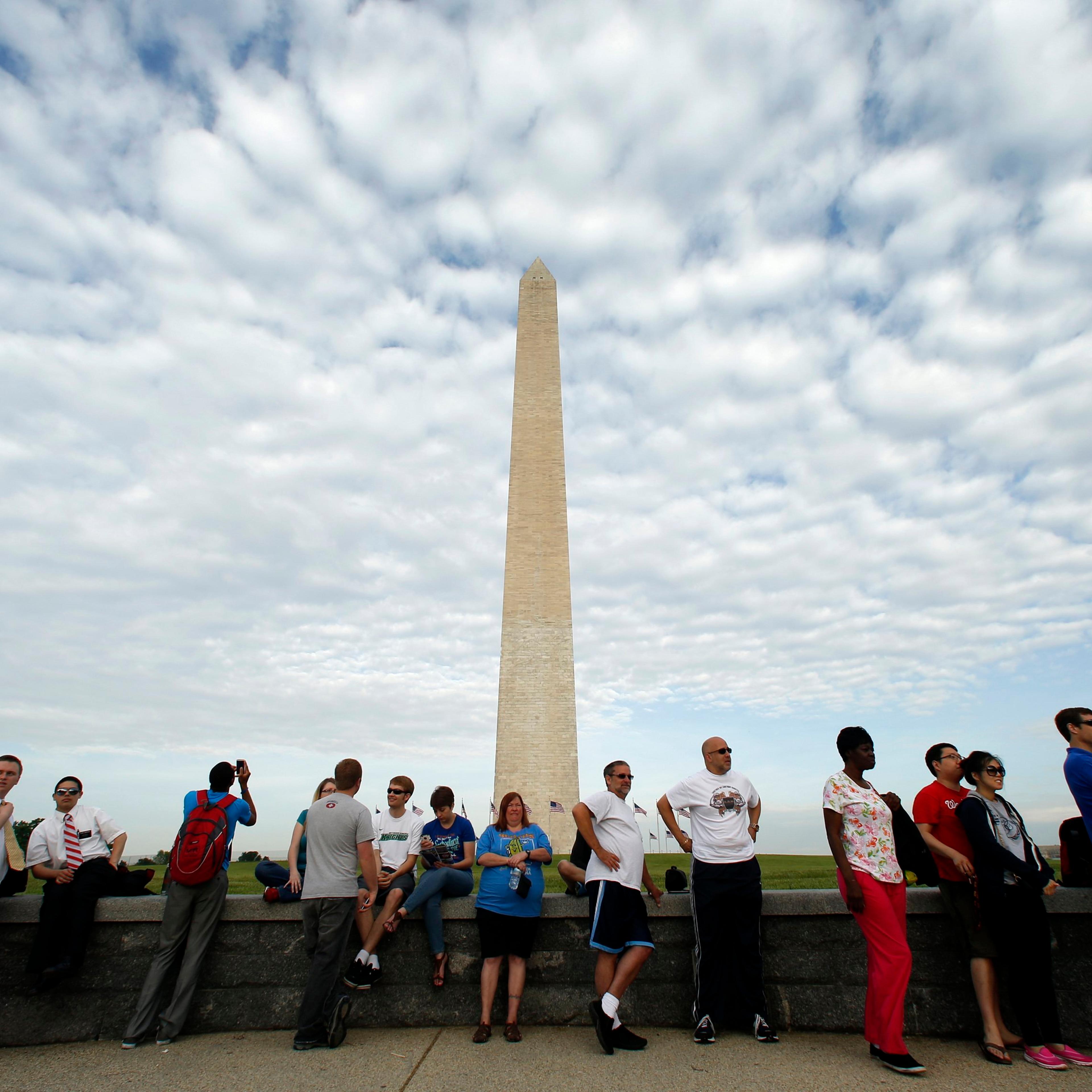 The very first visitors in line wait to purchase tickets to the re-opened Washington Monument in Washington, D.C., on May 12, 2014.