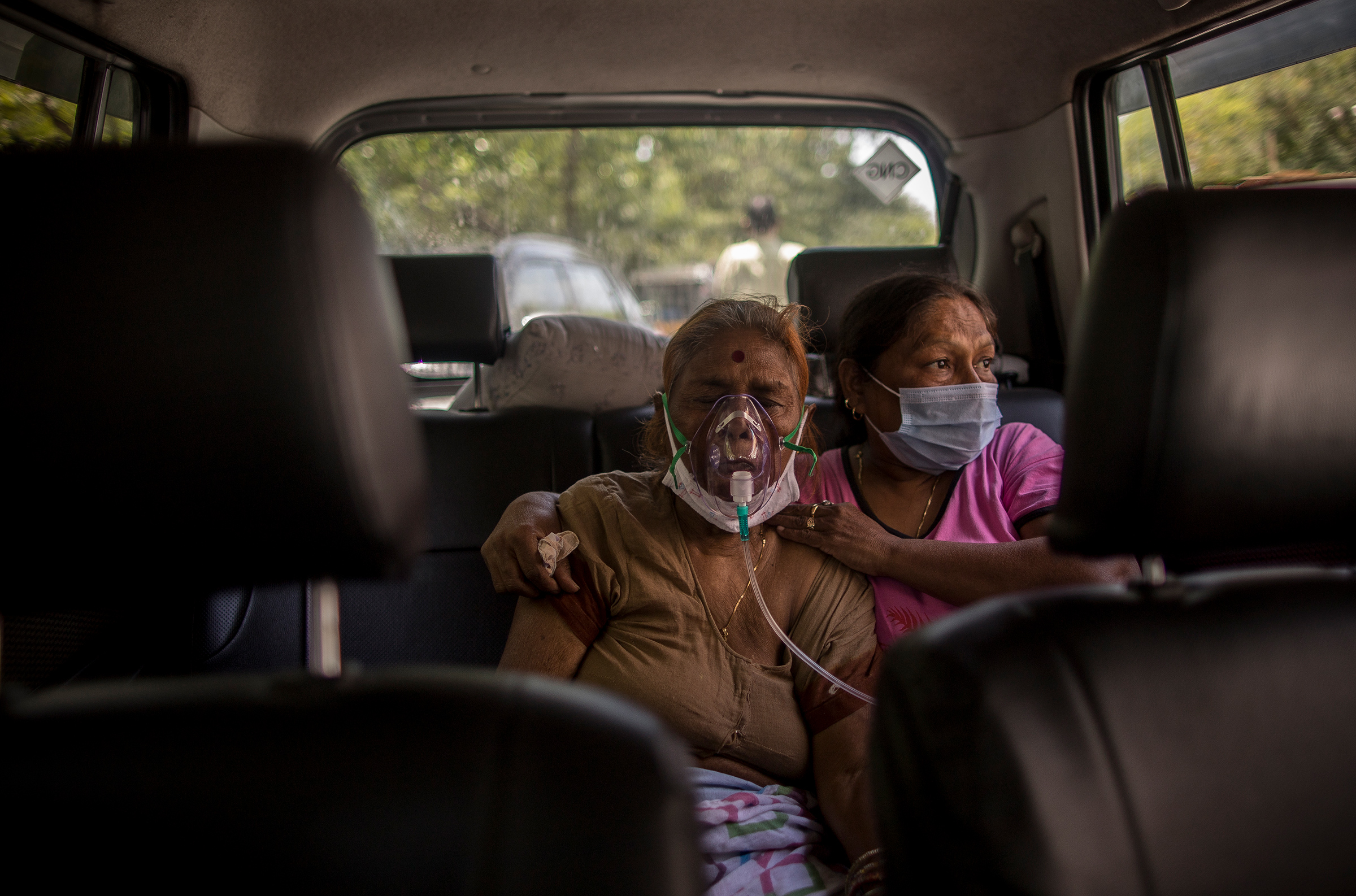 A woman suffering from COVID-19 receives free oxygen in New Delhi on April 24, 2021.