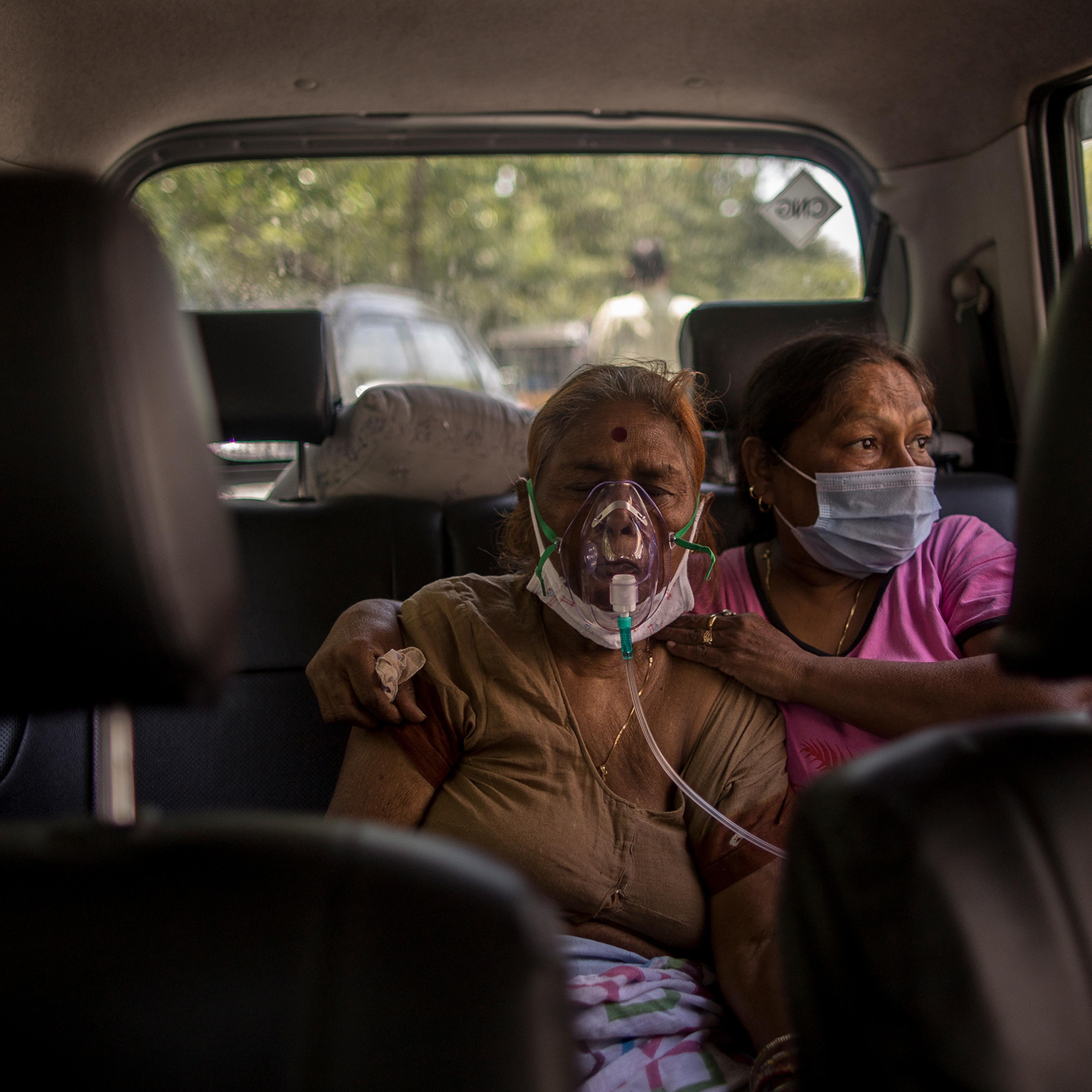 A woman suffering from COVID-19 receives free oxygen in New Delhi on April 24, 2021.