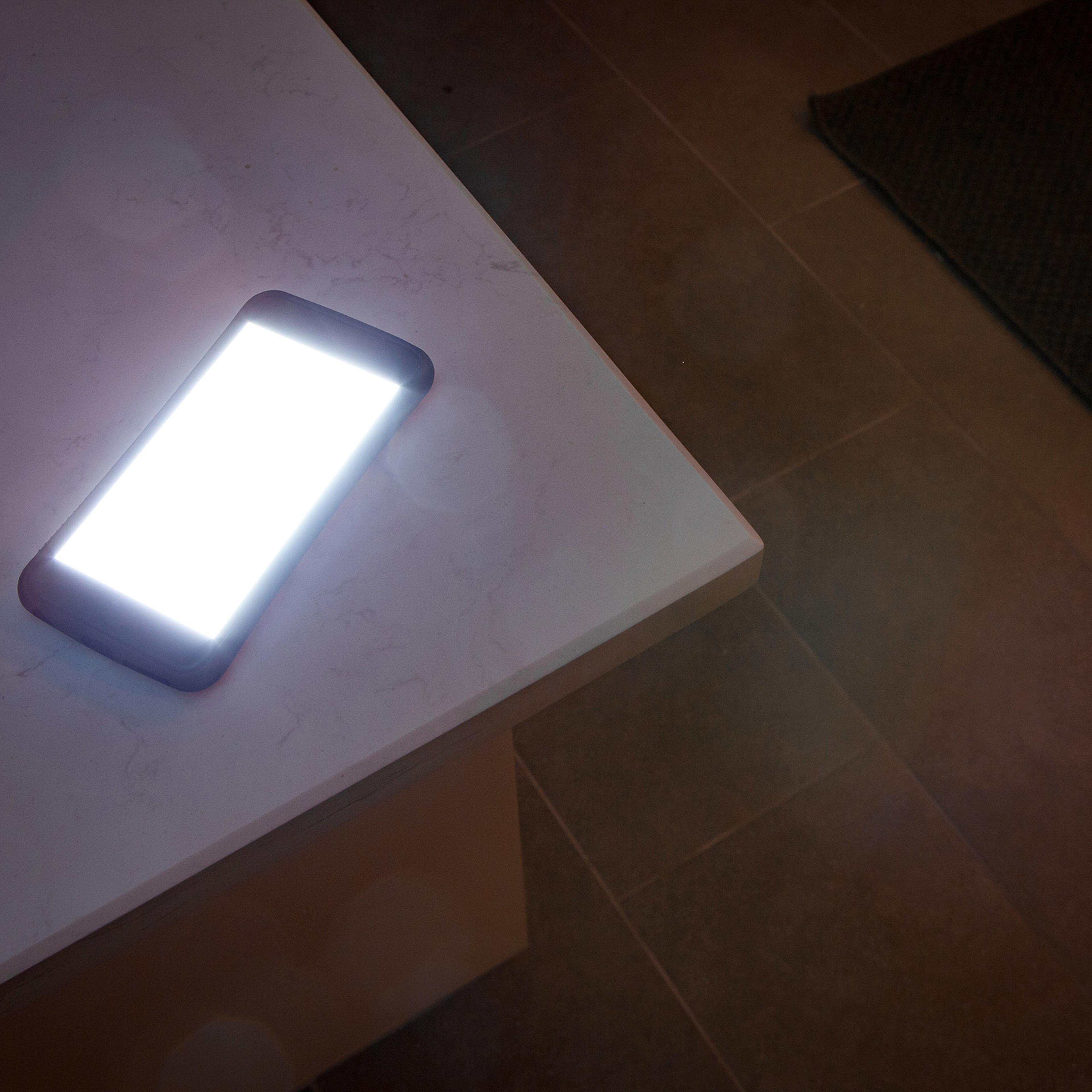 Glowing smartphone on countertop at night