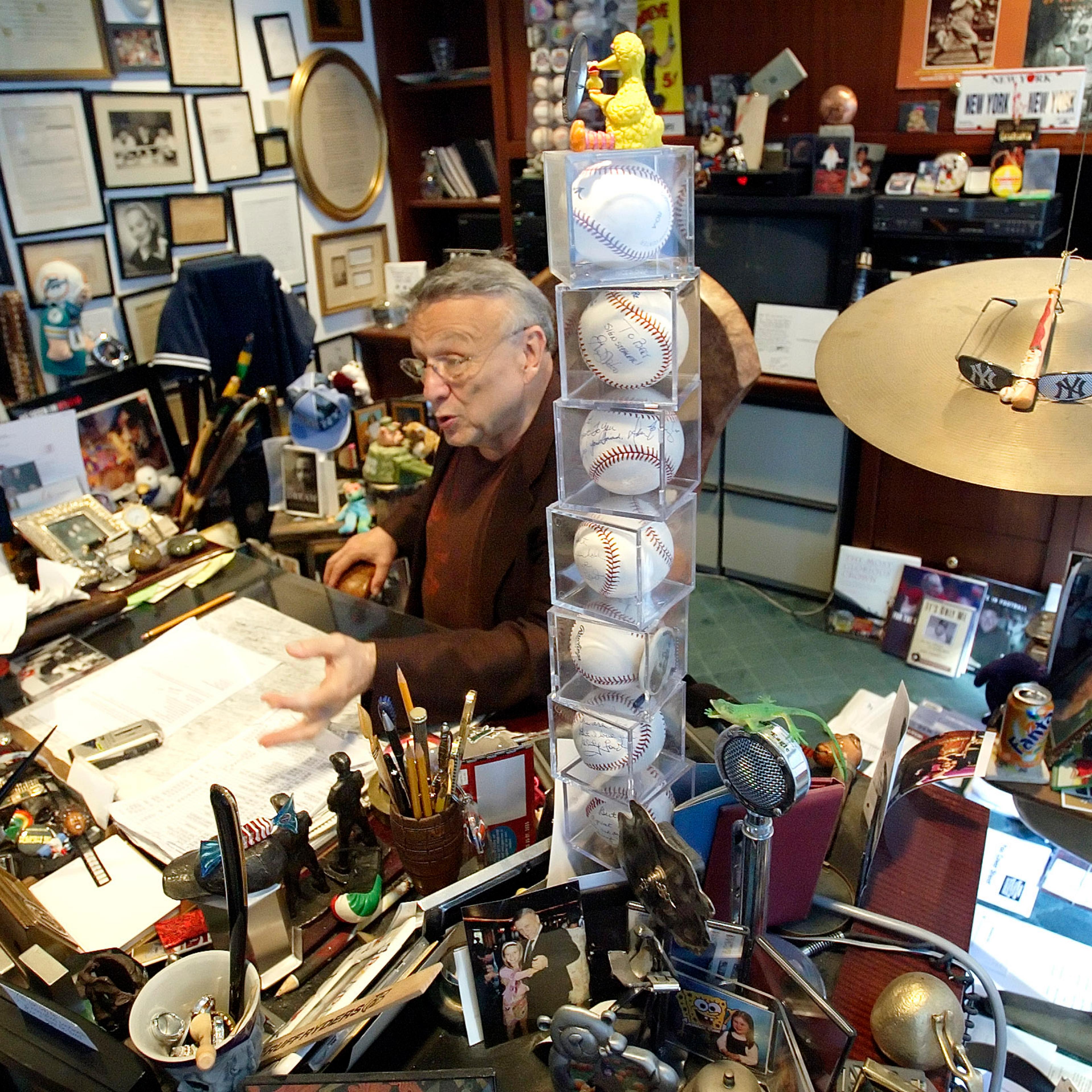 In this photo from Sept. 28, 2005, Bert Padell talks behind a tower of signed baseballs on his desk in his office in New York on Sept. 28, 2005.