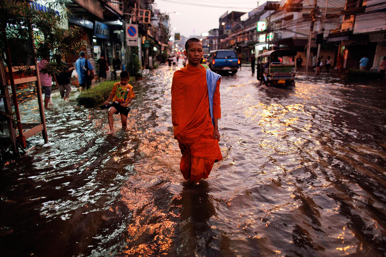 October 24, 2011. A Buddhist monk trudges through floodwaters in Bangkok. Thailand is experiencing its worst flooding in half a century. 