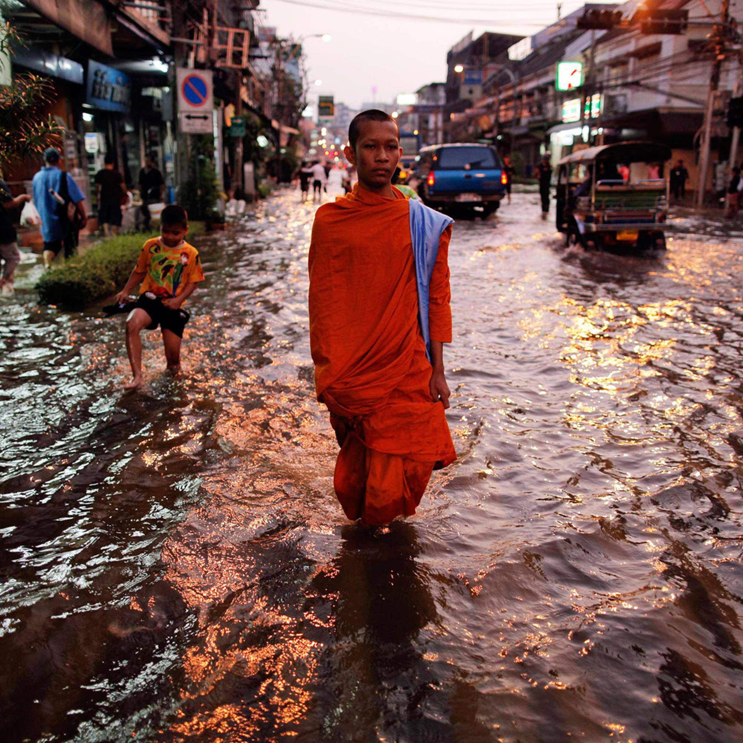 October 24, 2011. A Buddhist monk trudges through floodwaters in Bangkok. Thailand is experiencing its worst flooding in half a century.