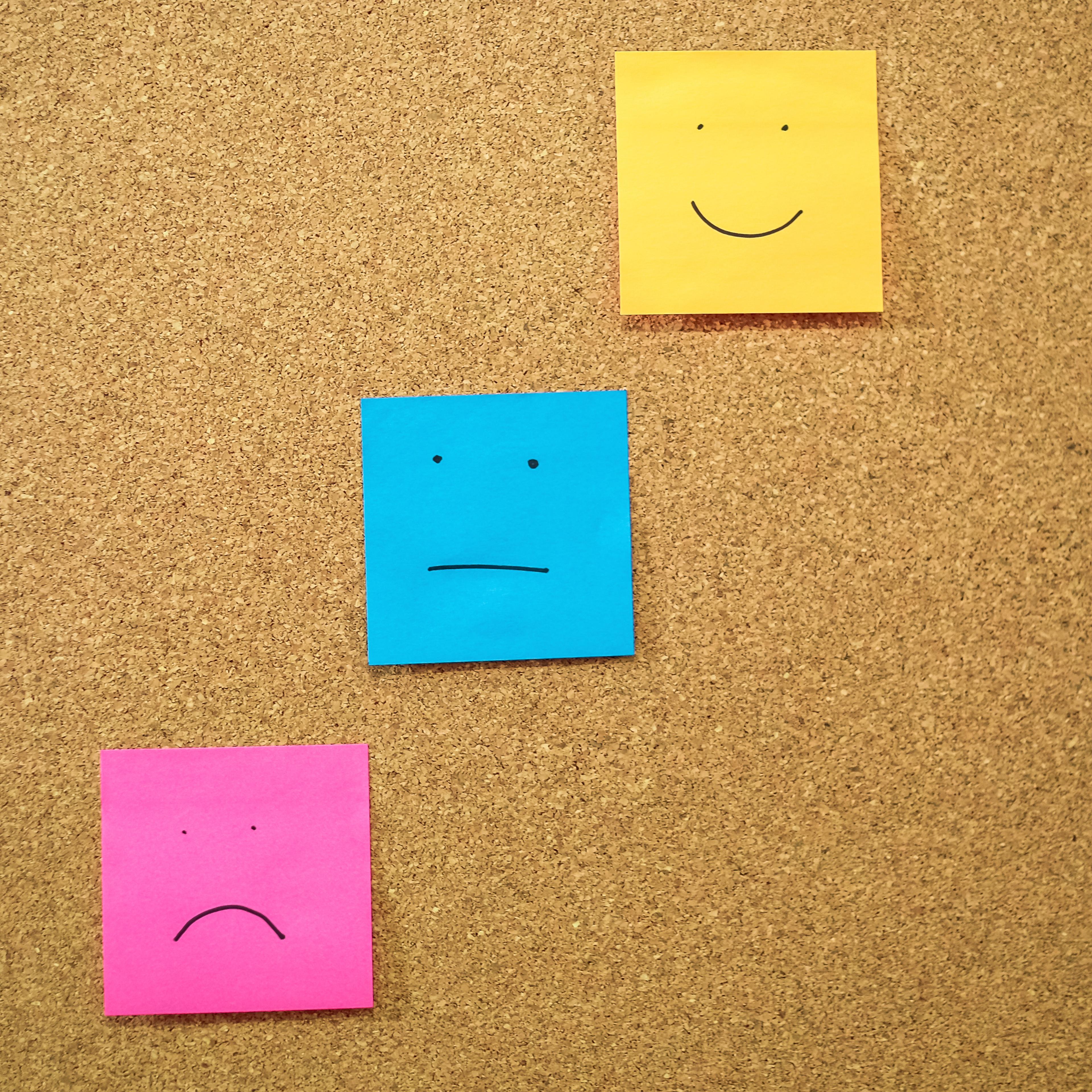 Colorful Papers With Anthropomorphic Faces Stuck On Wall
