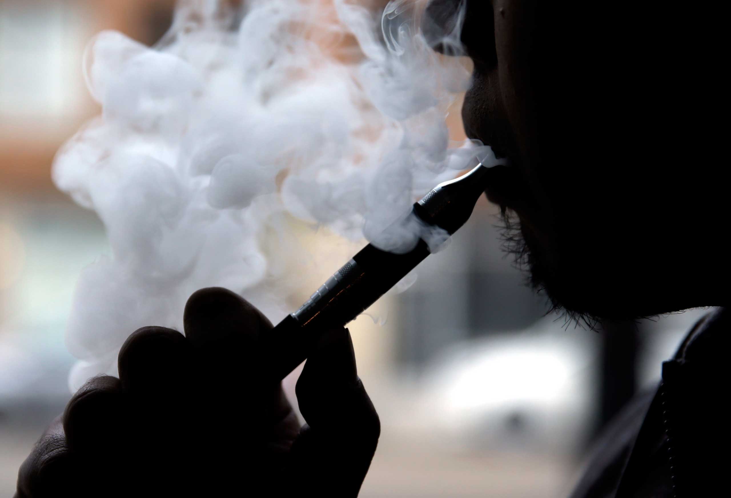 Man demonstrates an e-cigarette at Vape store in Chicago in 2014.
