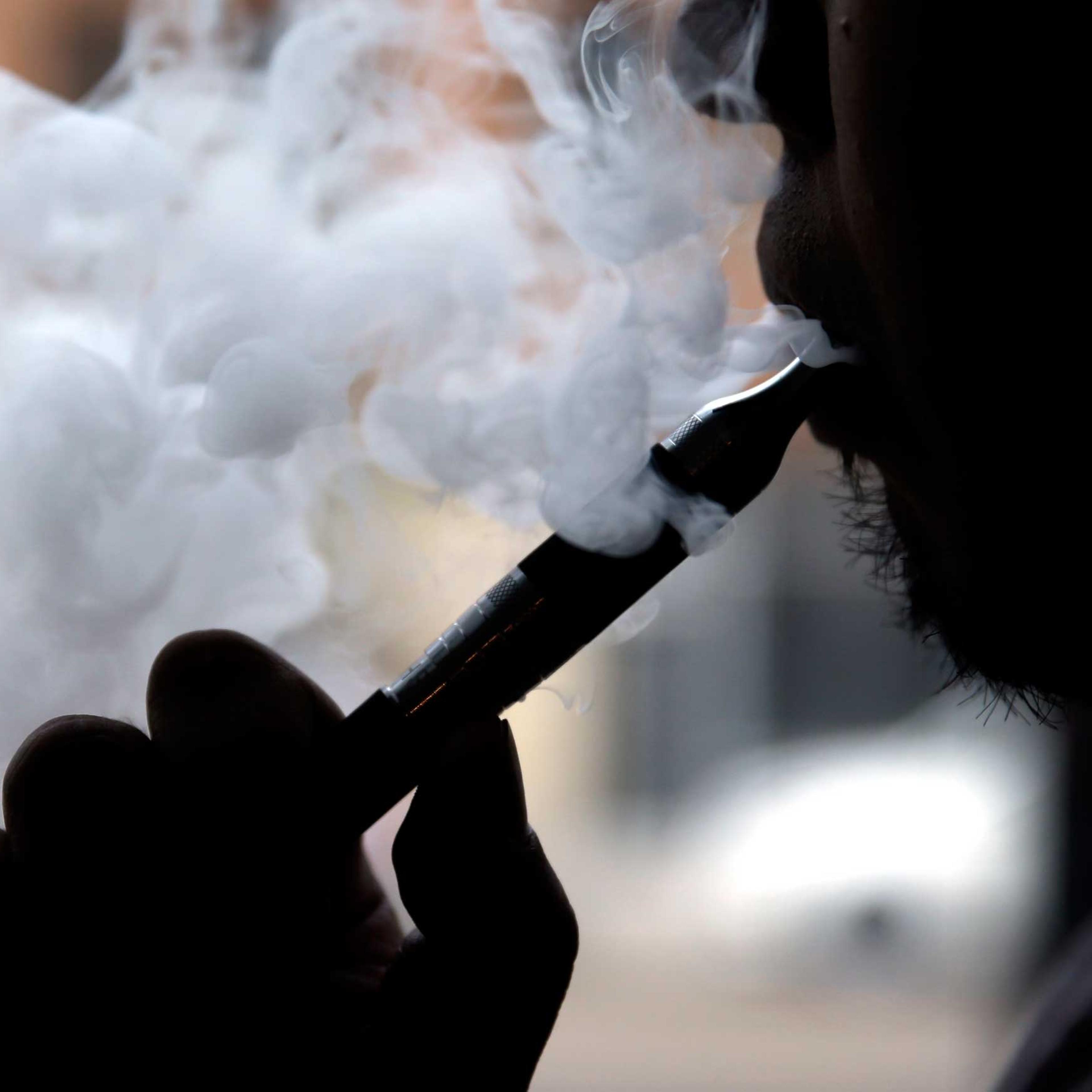 Man demonstrates an e-cigarette at Vape store in Chicago in 2014.