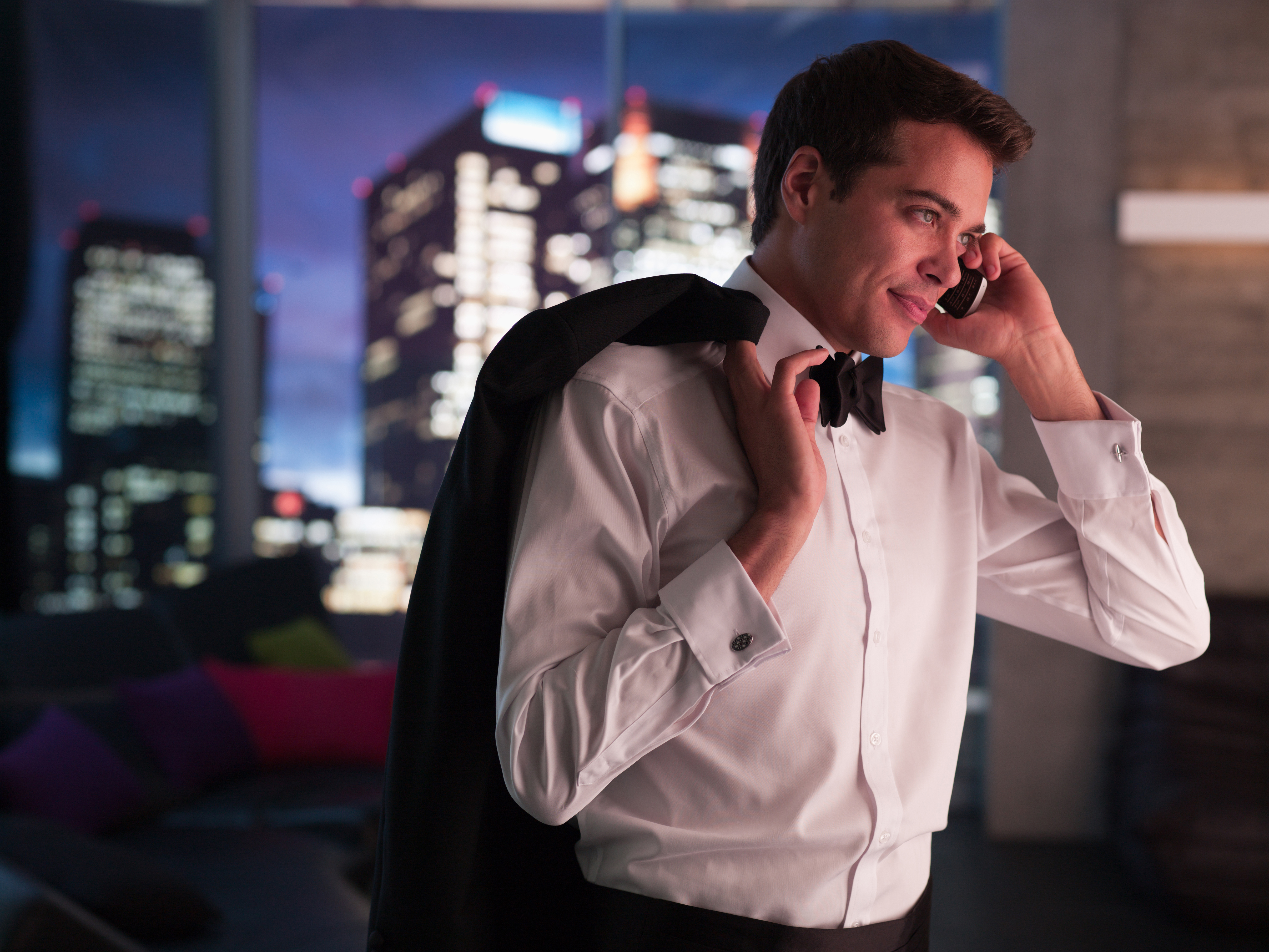 Man in tuxedo talking on cell phone