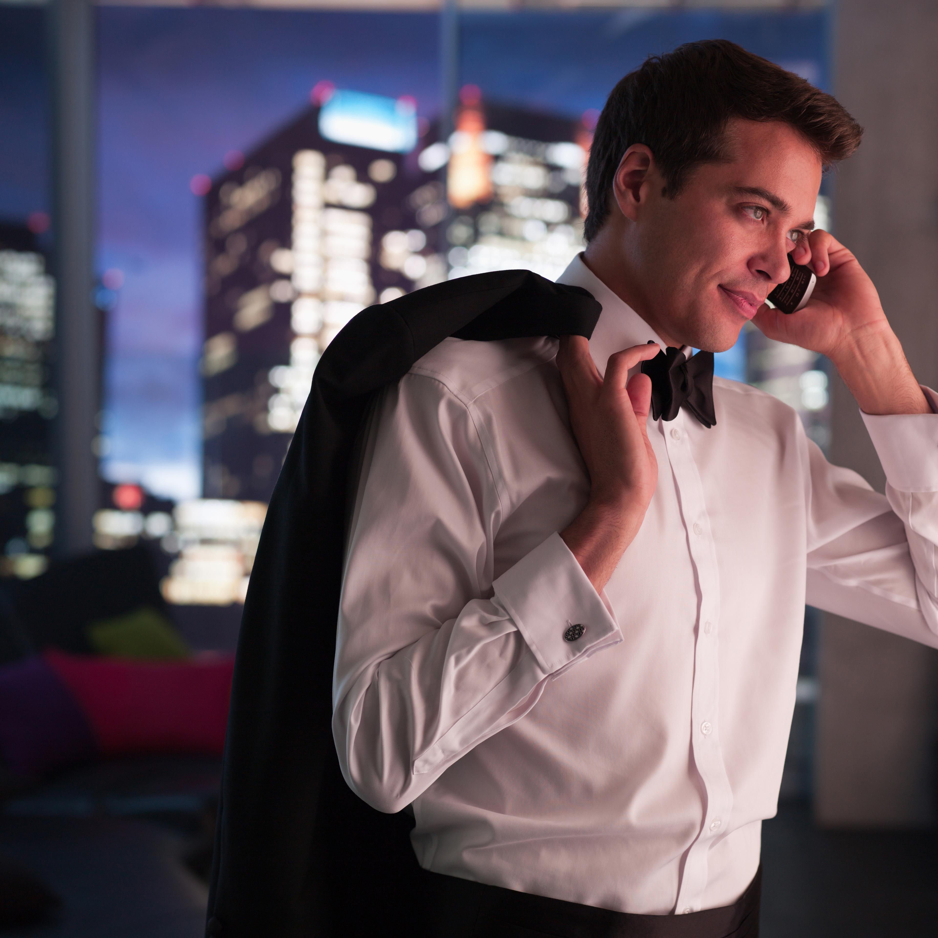 Man in tuxedo talking on cell phone