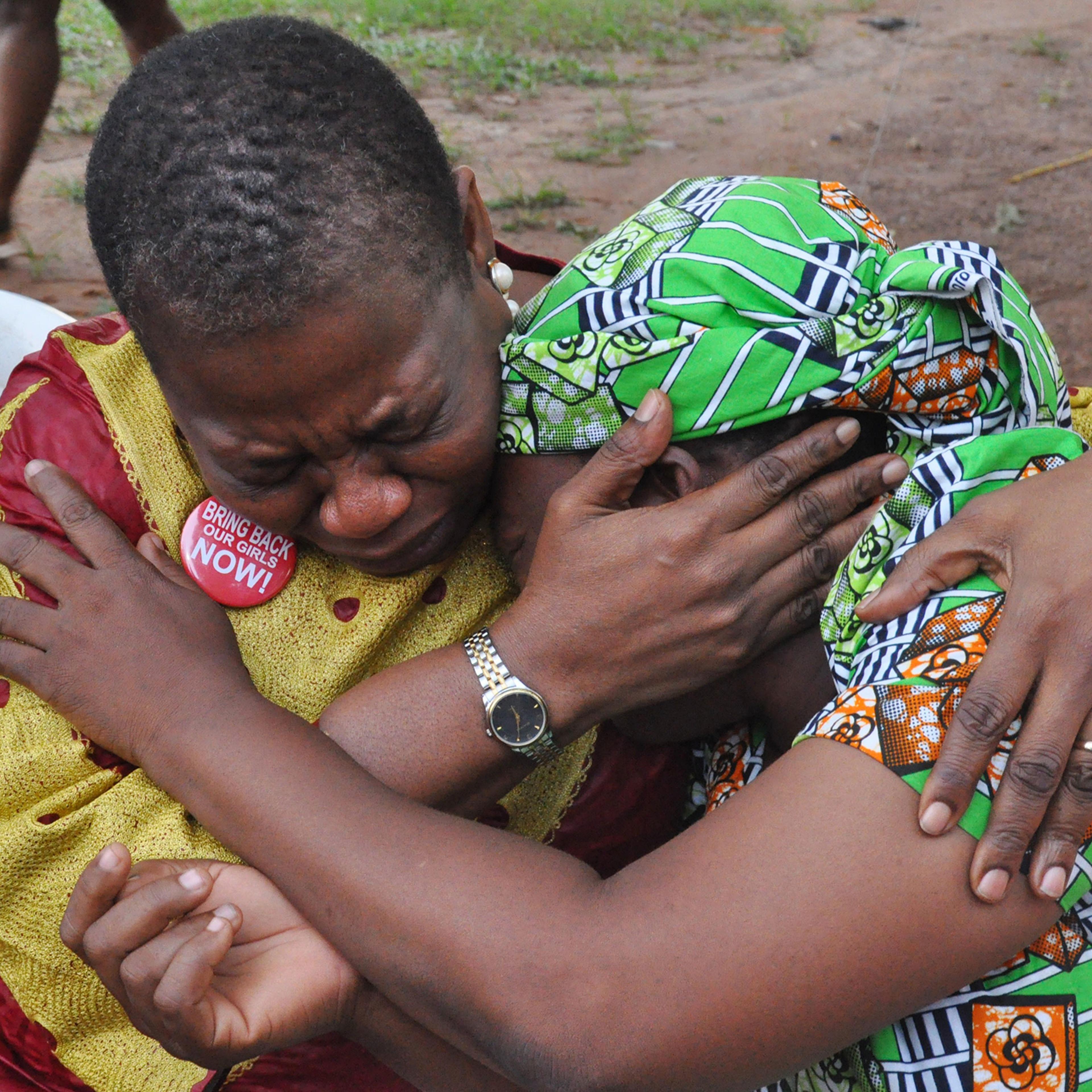 Ezekwesili comforts the mother of a girl kidnapped by Boko Haram in Abuja on Aug. 14, 2016