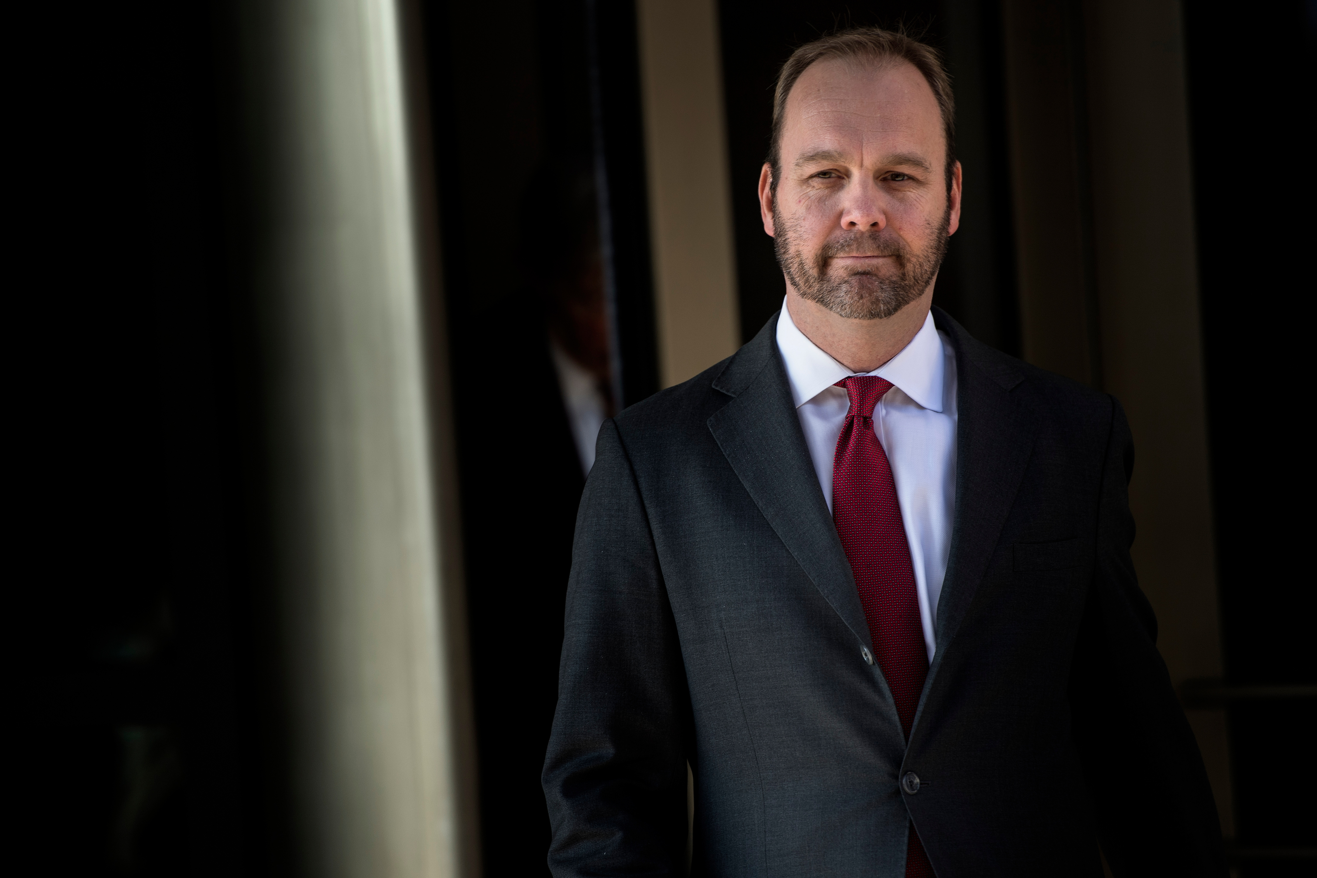 Rick Gates wears a suit and red tie