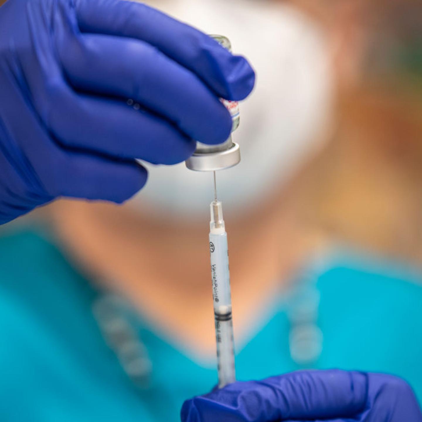 A nurse fills up a syringe with the Moderna COVID-19 vaccine at a vaccination site at a senior center on March 29, 2021 in San Antonio, Texas.