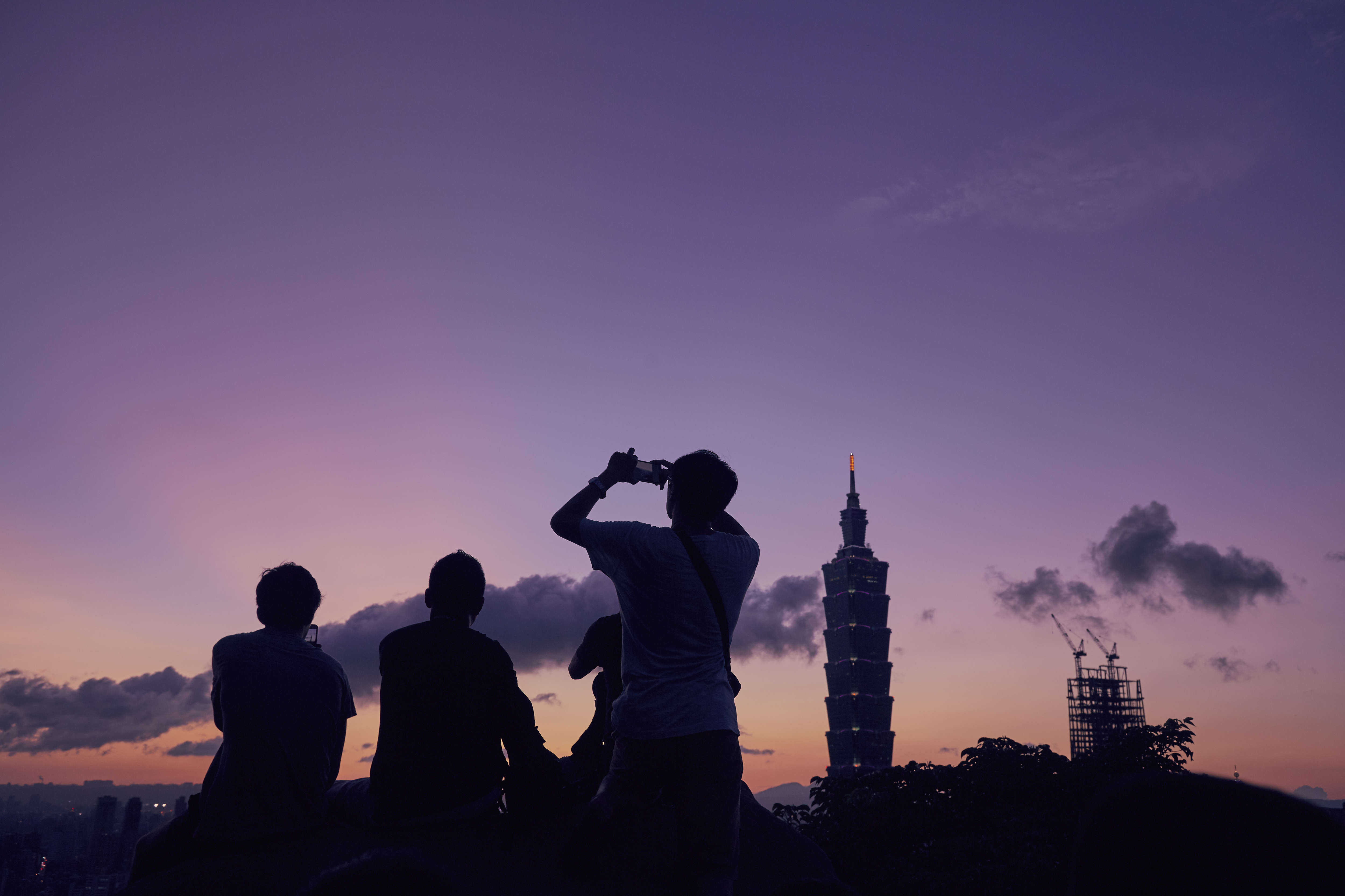 People gather the watch the last light as the sun sets over