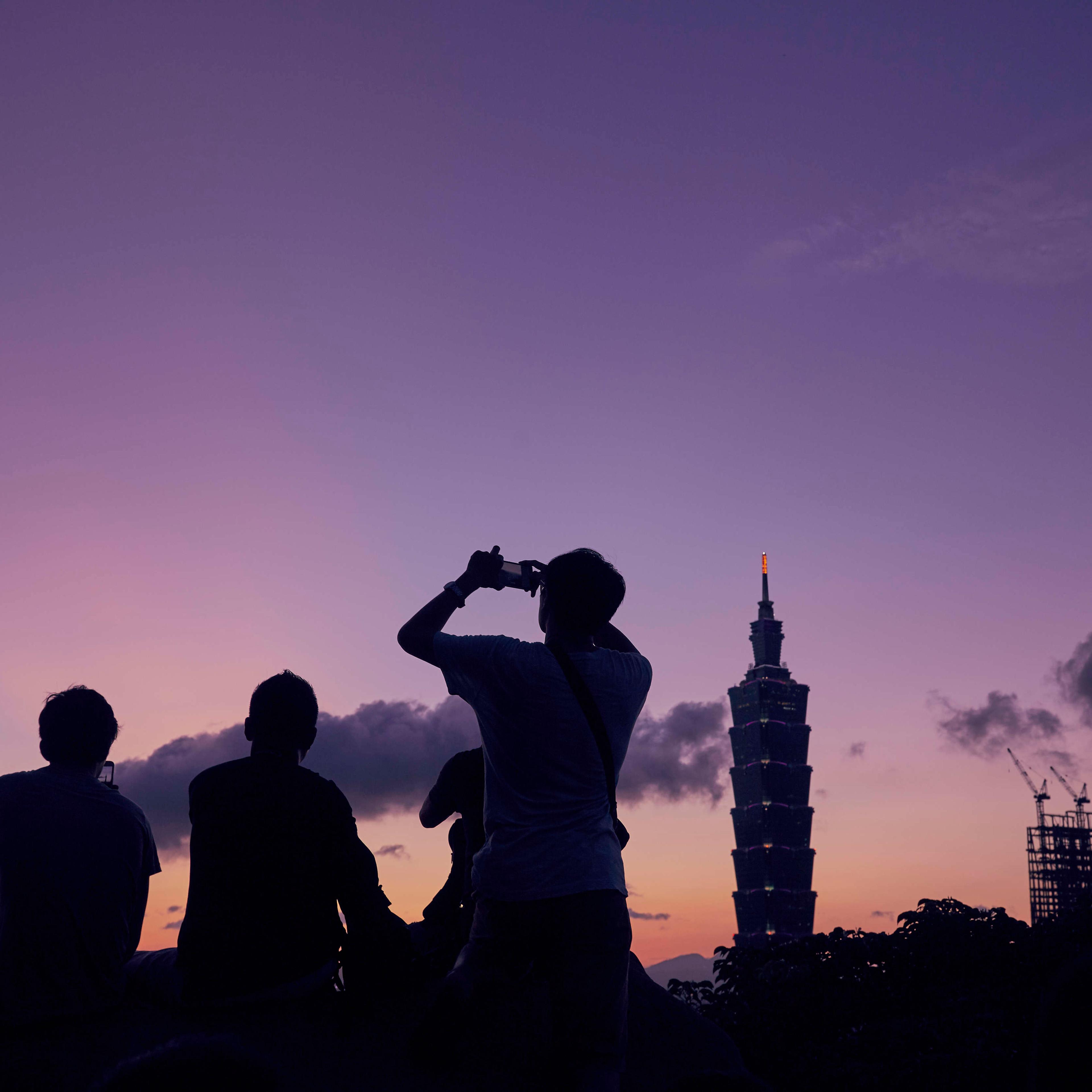 People gather the watch the last light as the sun sets over