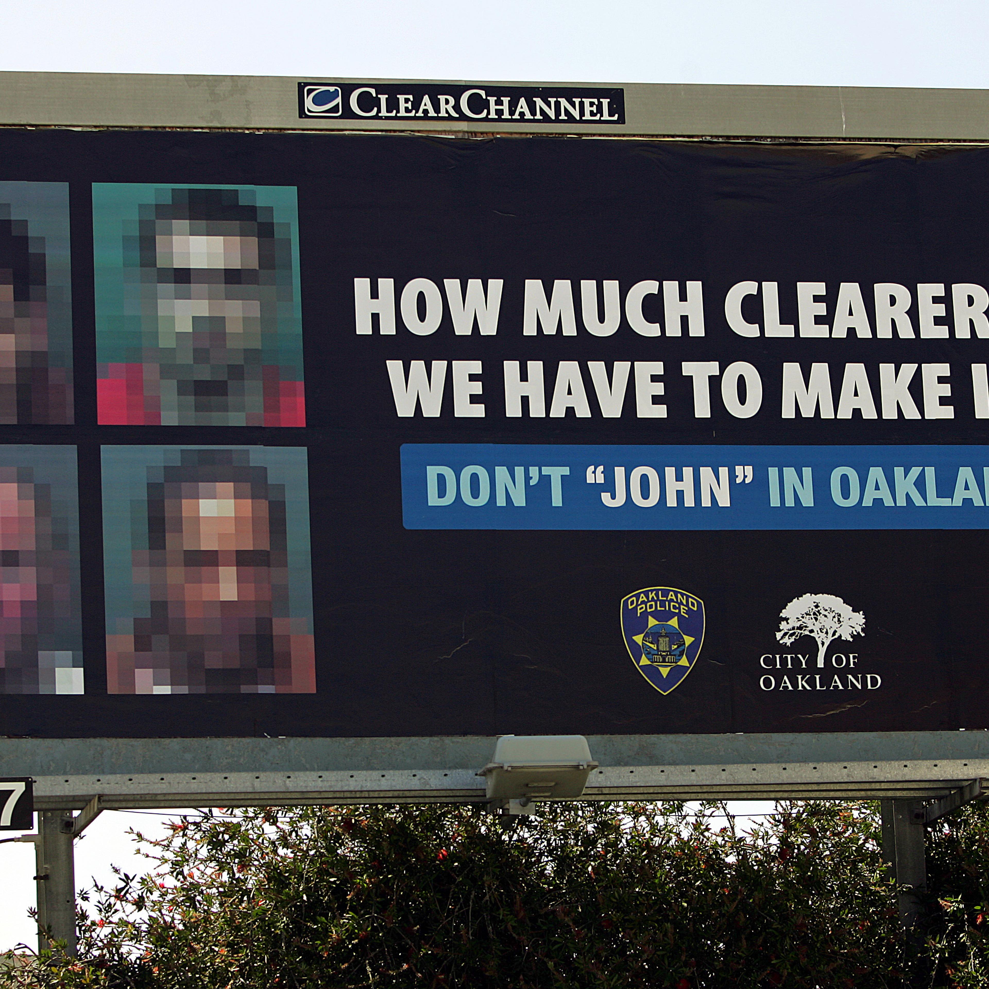 Images of four men convicted of soliciting prostitutes, intentionally blurred so they could not be recognized, are seen on a billboard on June 2, 2005, in Oakland, Calif.