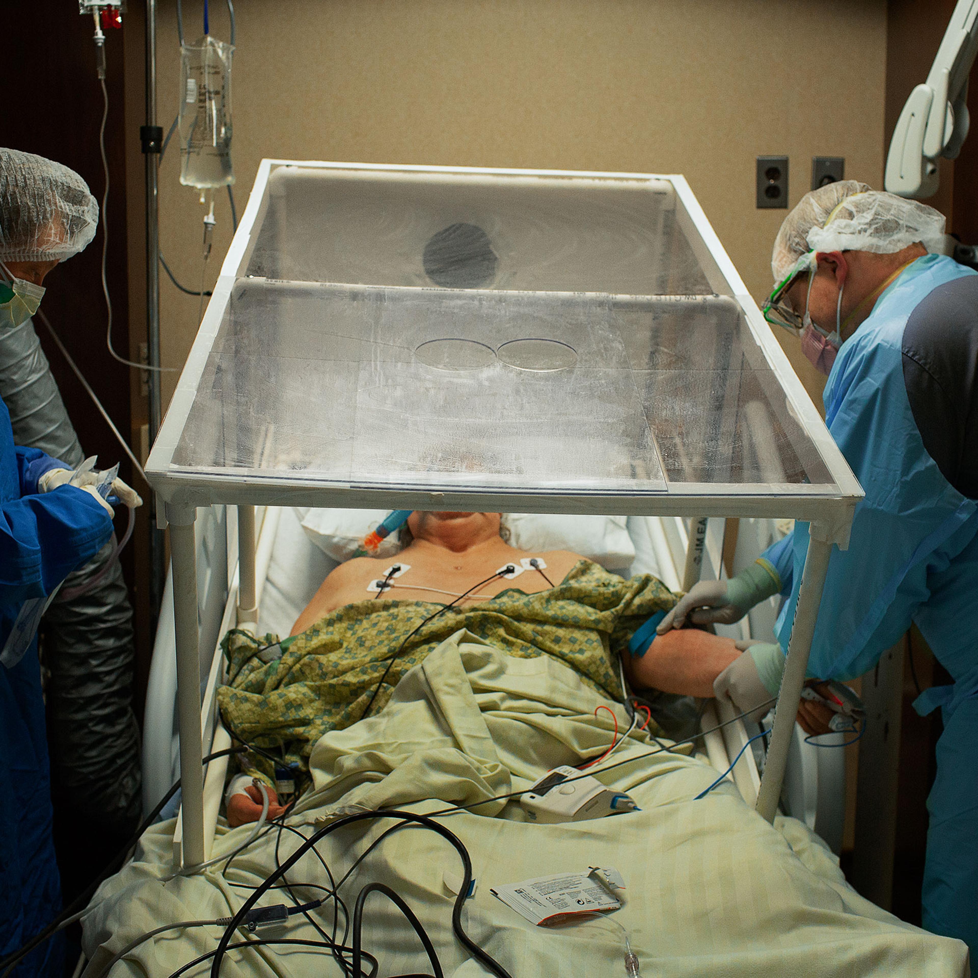 A COVID-19 patient is prepared for intubation by the anesthesiologist at Holy Name Medical Center in Teaneck, N.J., on March 31. The plastic tent is so the virus isn’t spread while transporting the patient between units.