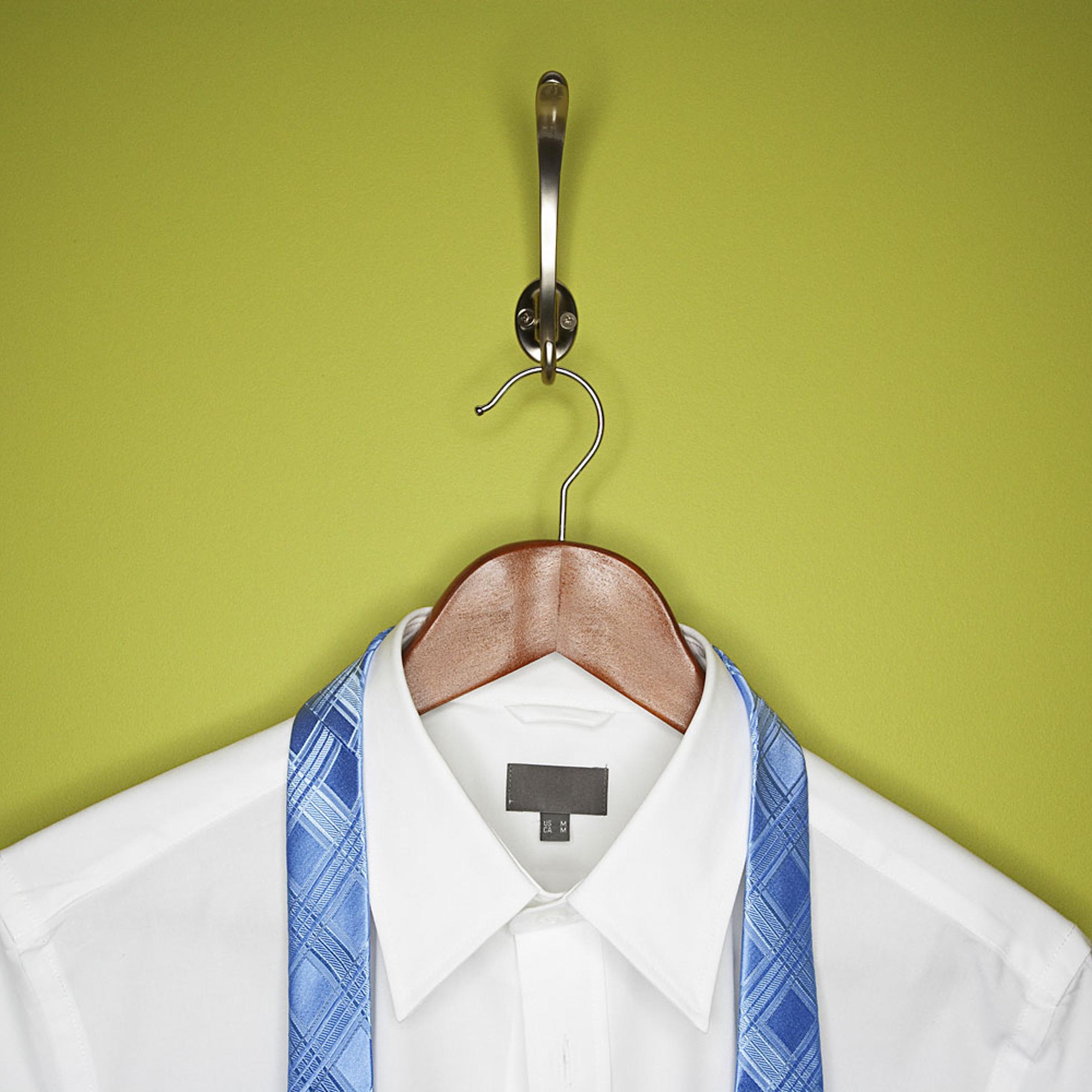 Stock image of a dress shirt and tie on hanger