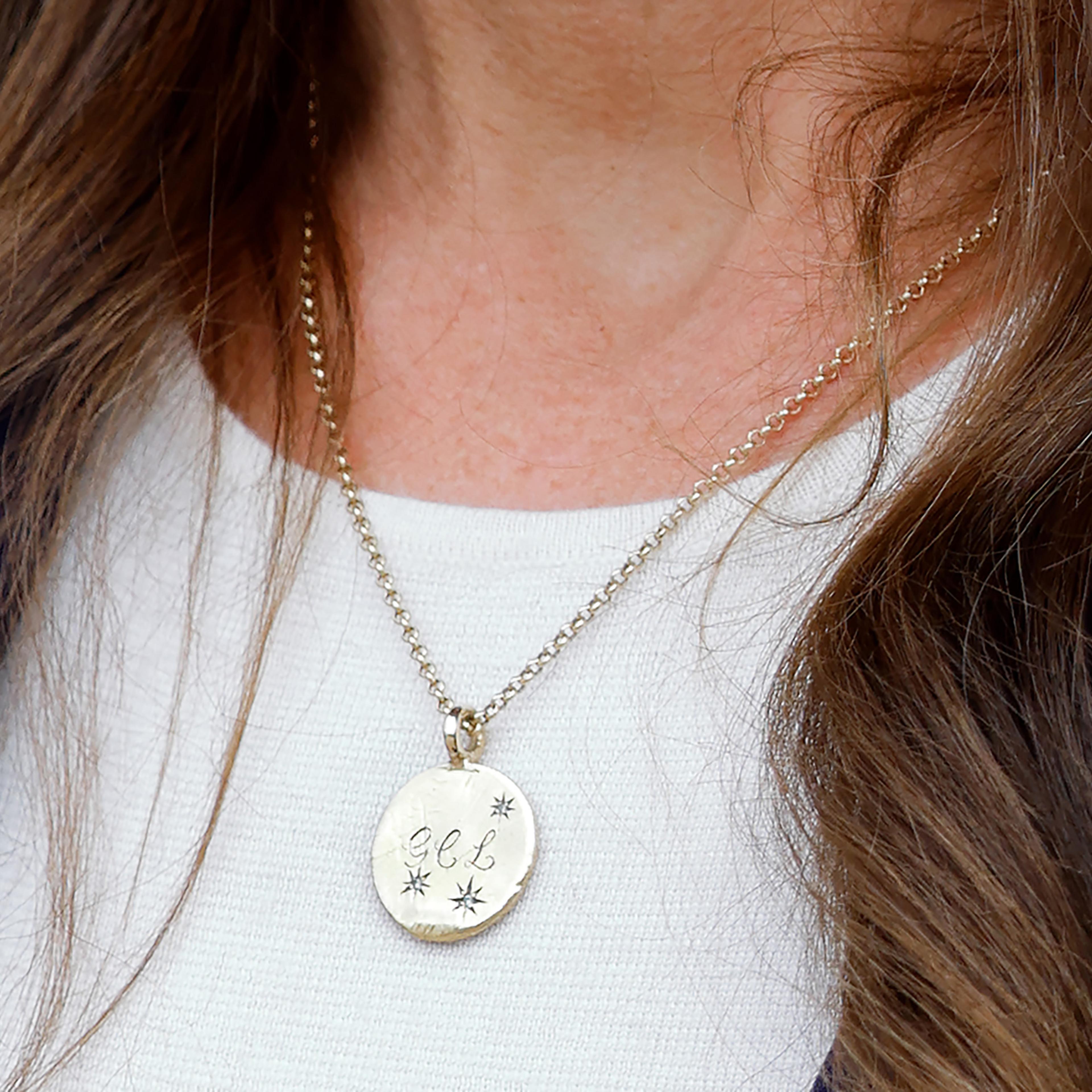 Catherine, Princess of Wales, wears a necklace bearing the initials G, C and L of her children Prince George of Wales, Princess Charlotte of Wales and Prince Louis of Wales.