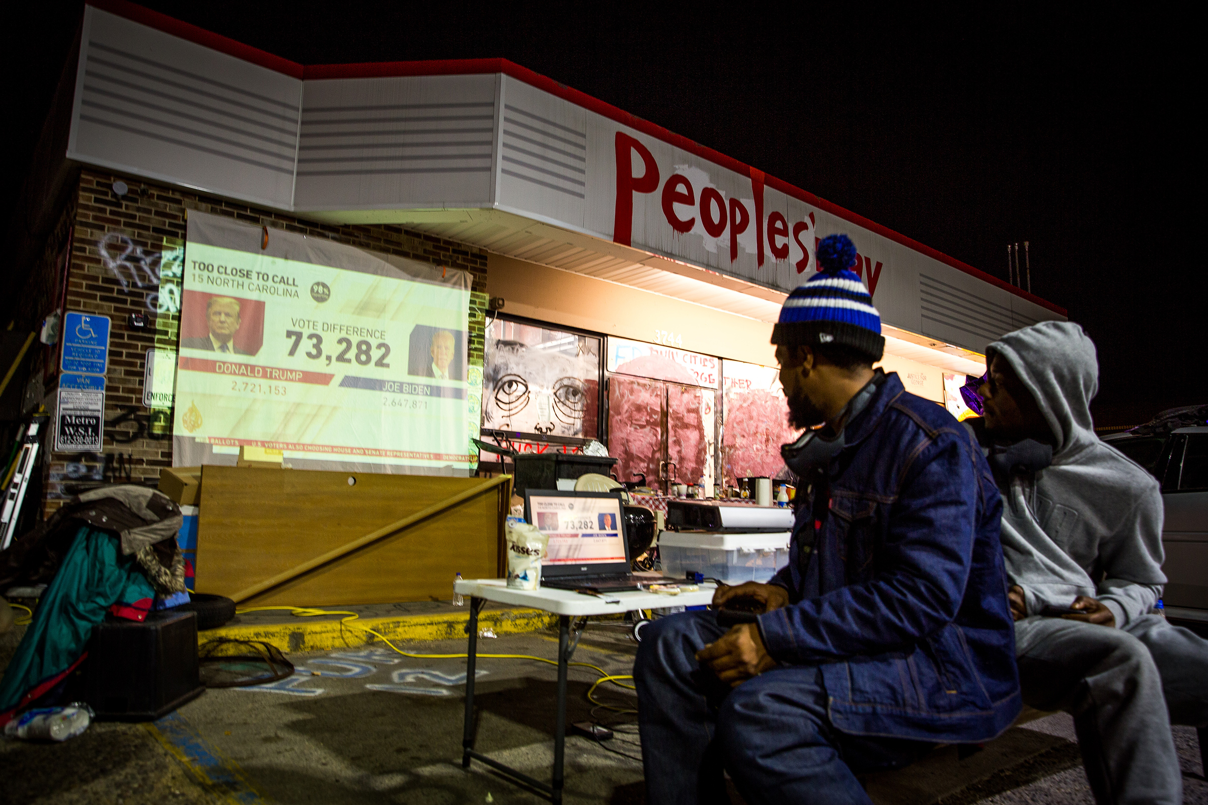 A projector is set up at a George Floyd memorial in Minneapolis for the community to watch election results
