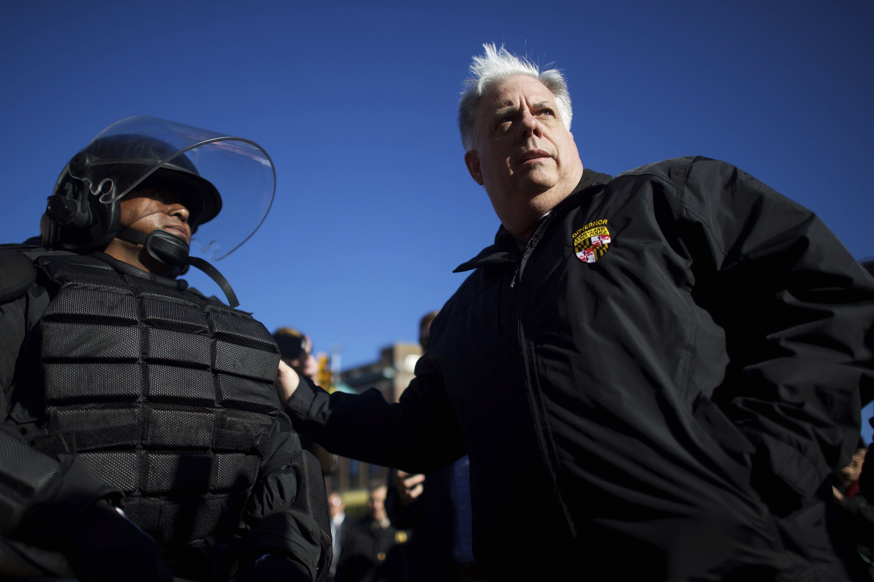 Maryland Governor Larry Hogan greets Baltimore police dressed in riot gear the morning after citywide riots following the funeral of Freddie Gray, on April 28, 2015 in Baltimore.