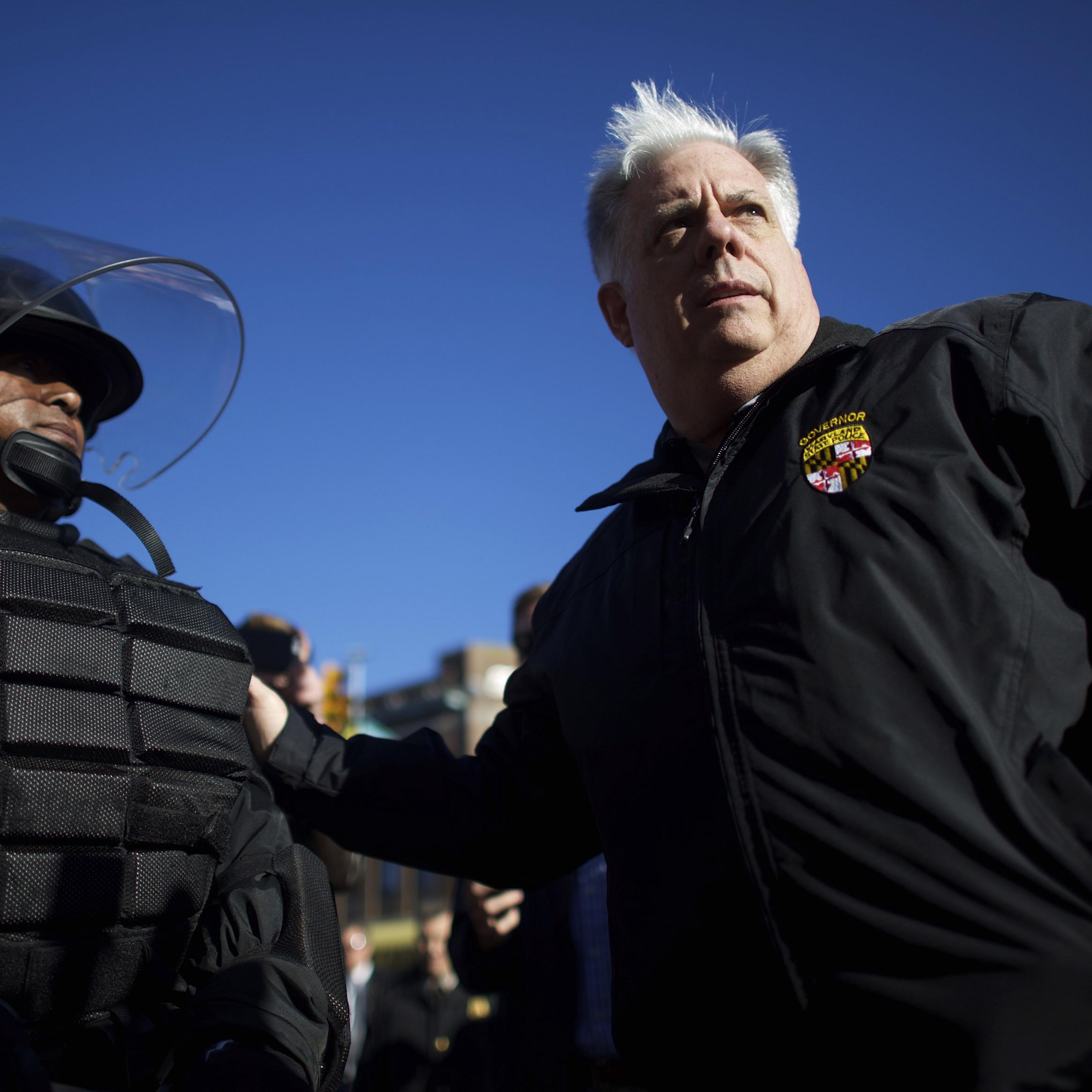 Maryland Governor Larry Hogan greets Baltimore police dressed in riot gear the morning after citywide riots following the funeral of Freddie Gray, on April 28, 2015 in Baltimore.