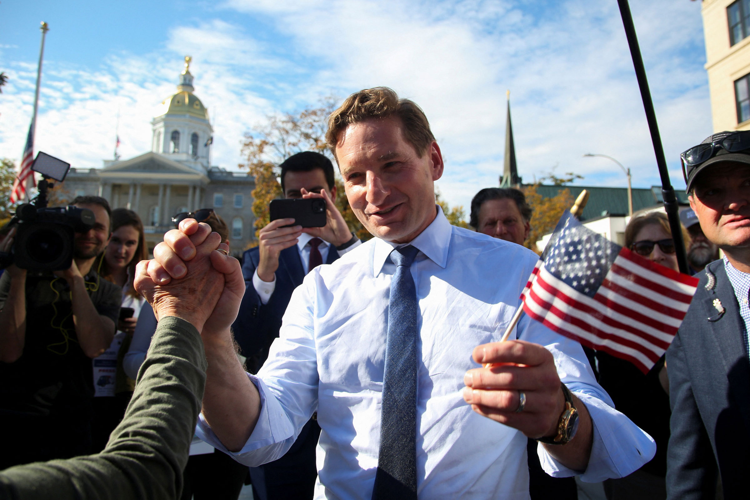 Dean Phillips holds hands with a supporter in New Hampshire