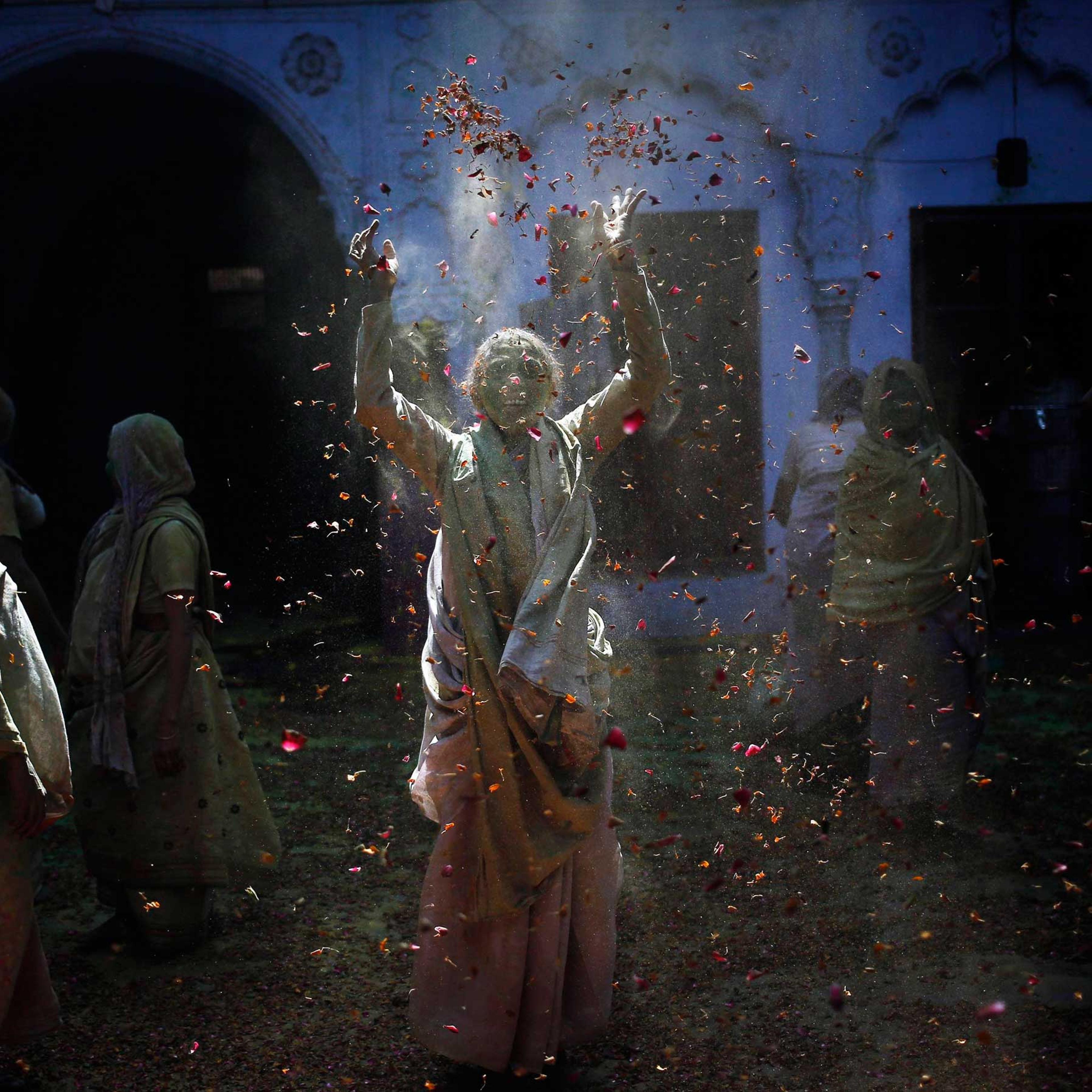 A widow throws flower petals as she, along with others, take part in the Holi celebrations organised by a non-governmental organisation Sulabh International at a widows' ashram at Vrindavan in the northern Indian state of Uttar Pradesh, March 4, 2015.