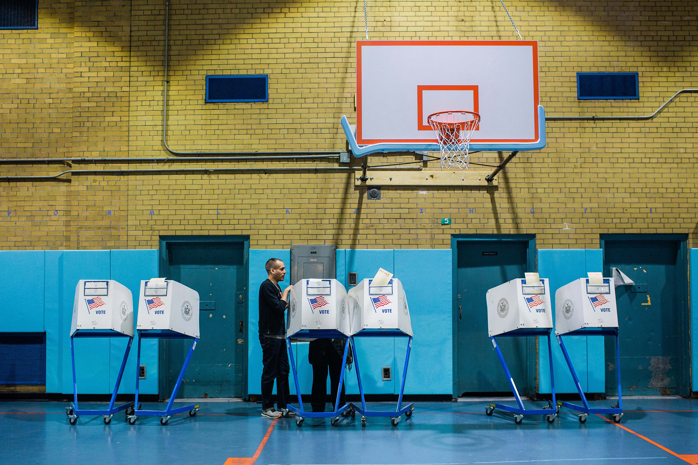 A poll worker explains the voting process to a voter at a public school polling location in New York on Tuesday, Nov. 5, 2019. (Gabriela Bhaskar/The New York Times)
