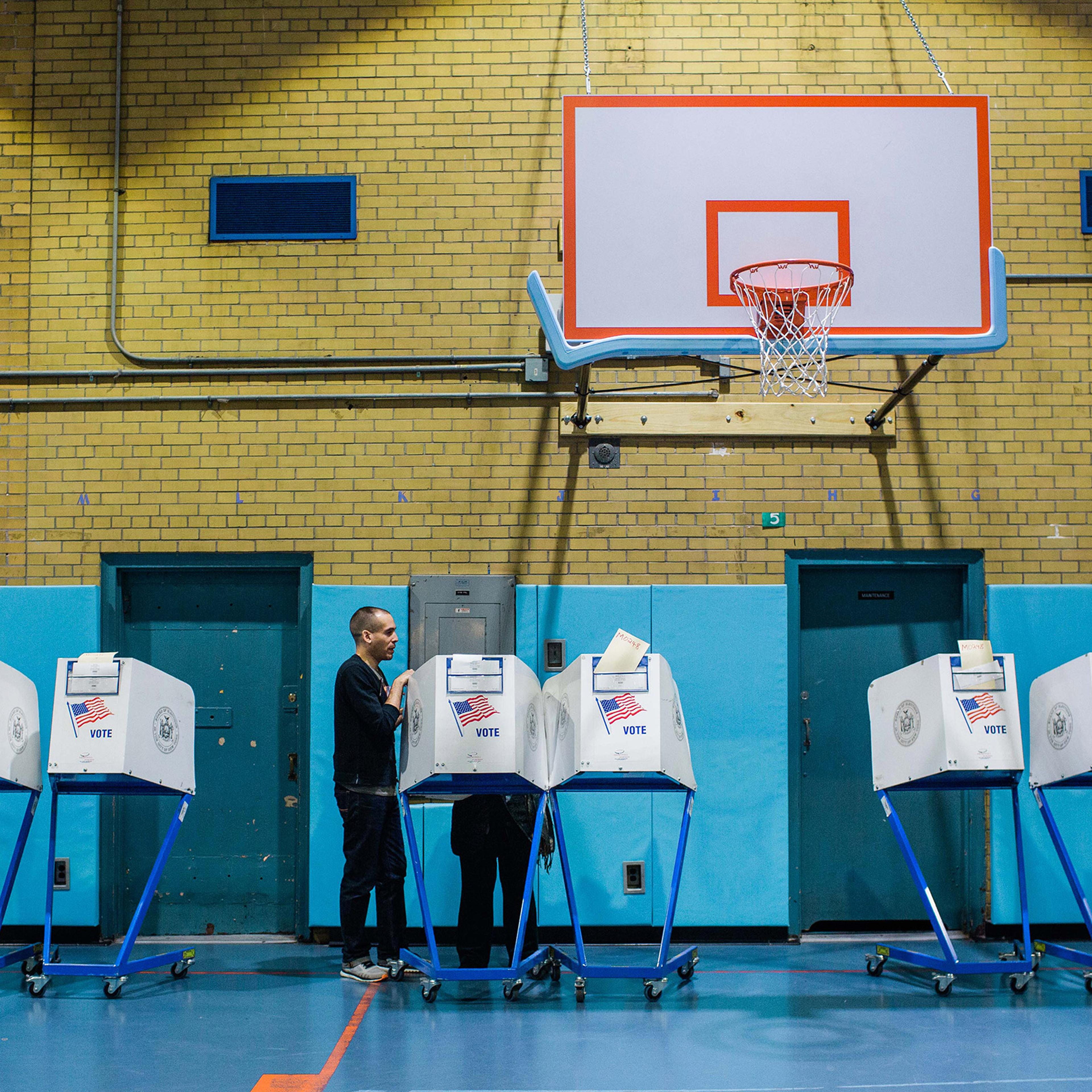 A poll worker explains the voting process to a voter at a public school polling location in New York on Tuesday, Nov. 5, 2019. (Gabriela Bhaskar/The New York Times)