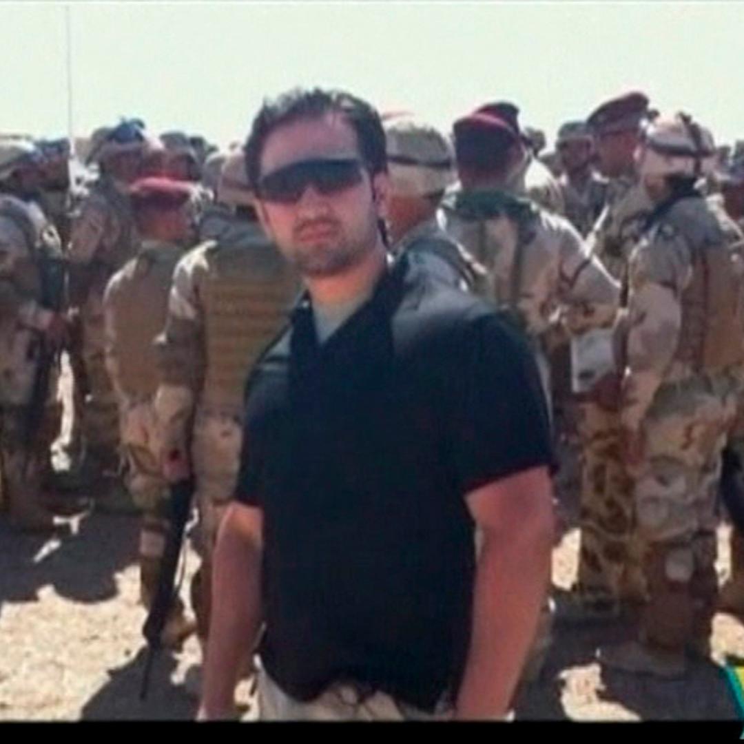 Iranian-American Amir Mirza Hekmati, who has been sentenced to death by Iran's Revolutionary Court on the charge of spying for the CIA, stands with Iraqi soldiers in this undated still image taken from video in an undisclosed location