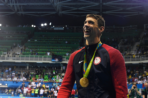 Michael Phelps laughs after being presented with his 20th Olympic gold medal after winning the men's 200-meter butterfly at Rio 2016 on Tuesday, August 9, 2016.