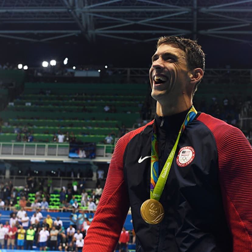 Michael Phelps laughs after being presented with his 20th Olympic gold medal after winning the men's 200-meter butterfly at Rio 2016 on Tuesday, August 9, 2016.
