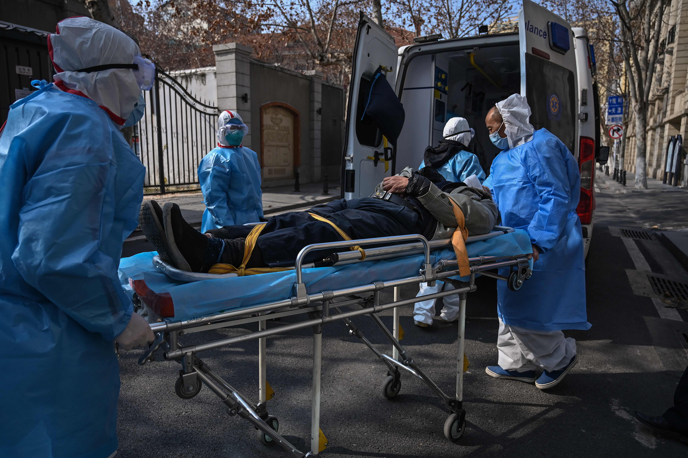 Medical staff in protective clothes carry a suspected coronavirus patient in Wuhan, China, on Jan. 30.