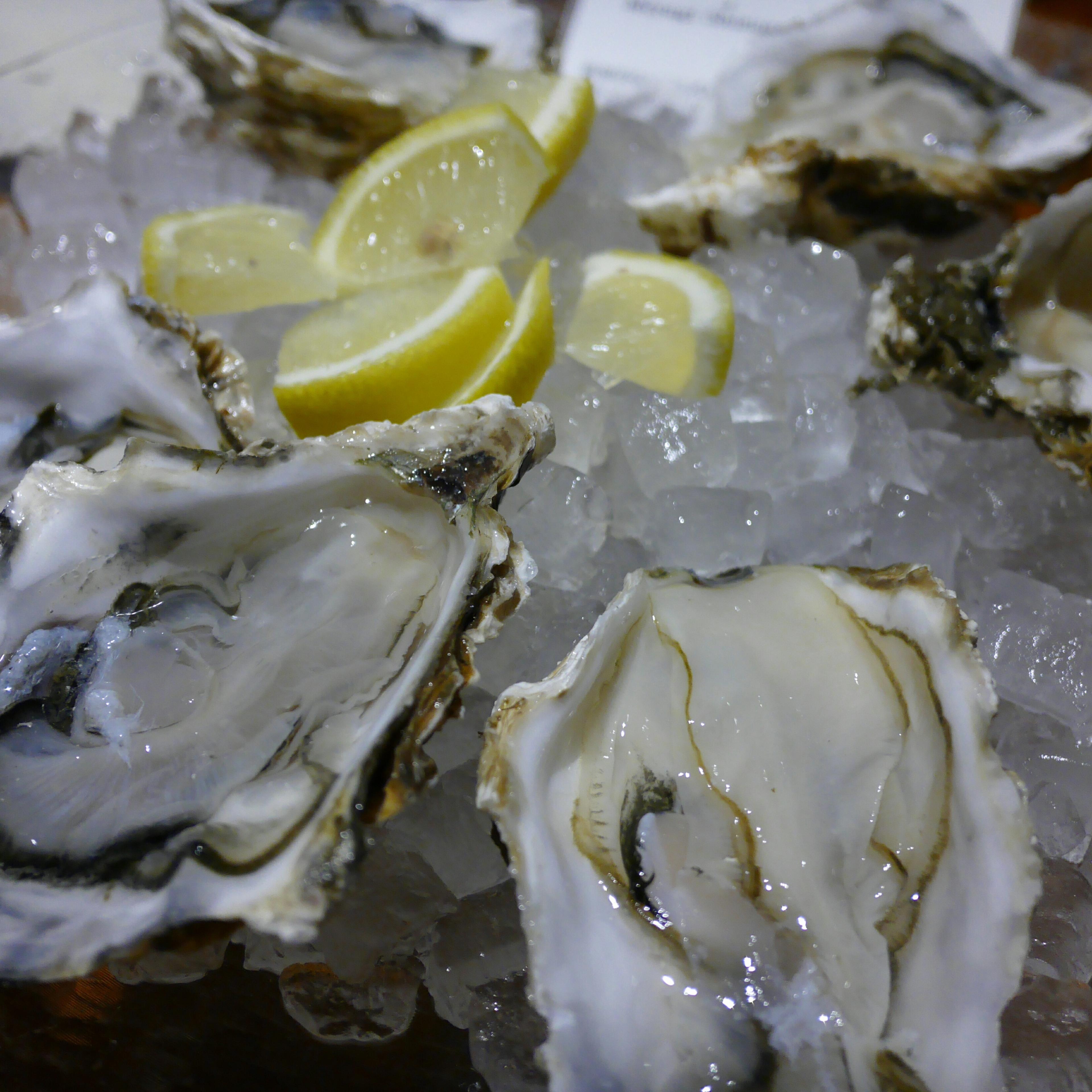 Close-Up Of Oysters And Lemon Slices On Ice