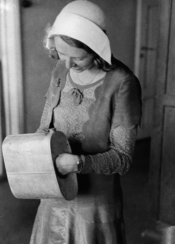 Finland's fight against bootlegging (Series): Woman is showing how bootleggers used a muff (or handwarmer) to transport alcohol - Photographer: Felix H. Man - Dephot- Published by: 'Berliner Illustrirte Zeitung' 37/1931Vintage property of ullstein bi