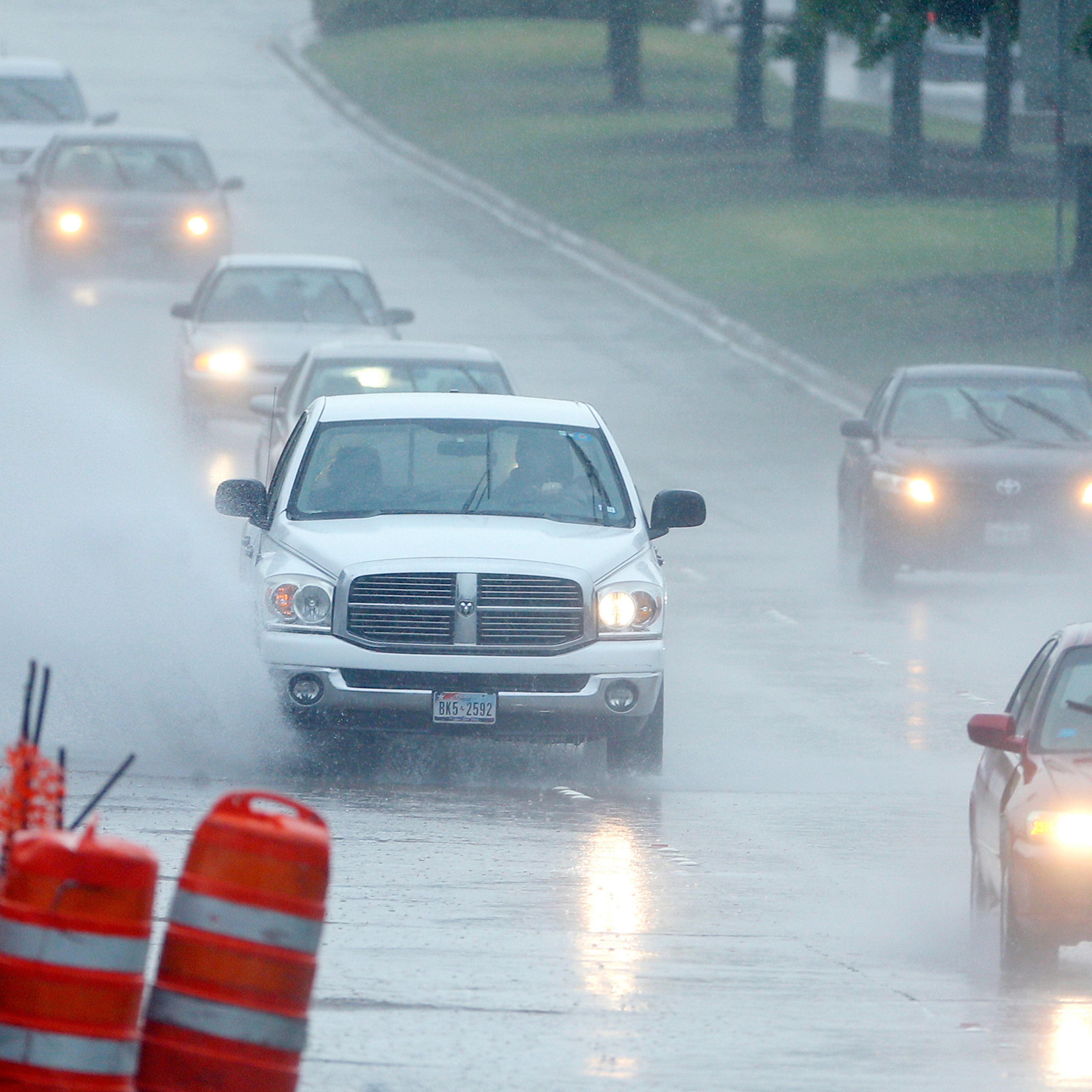 Drivers navigate through a heavy rain shower in Richardson, Texas, April 17, 2016.