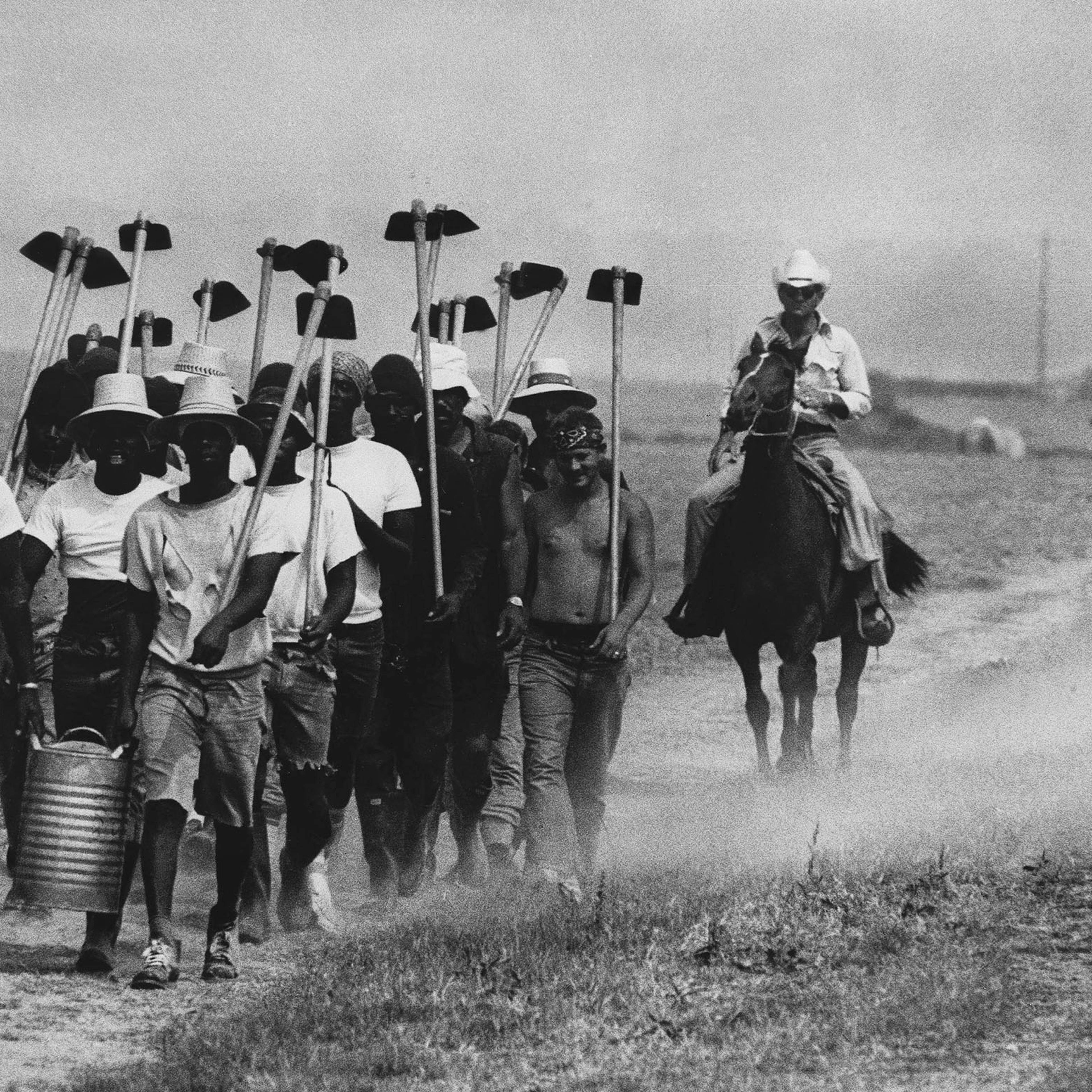 Inmates at Louisiana State Prison in Angola, La., march down a dusty trail on May 30, 1977, en route to working in the fields.