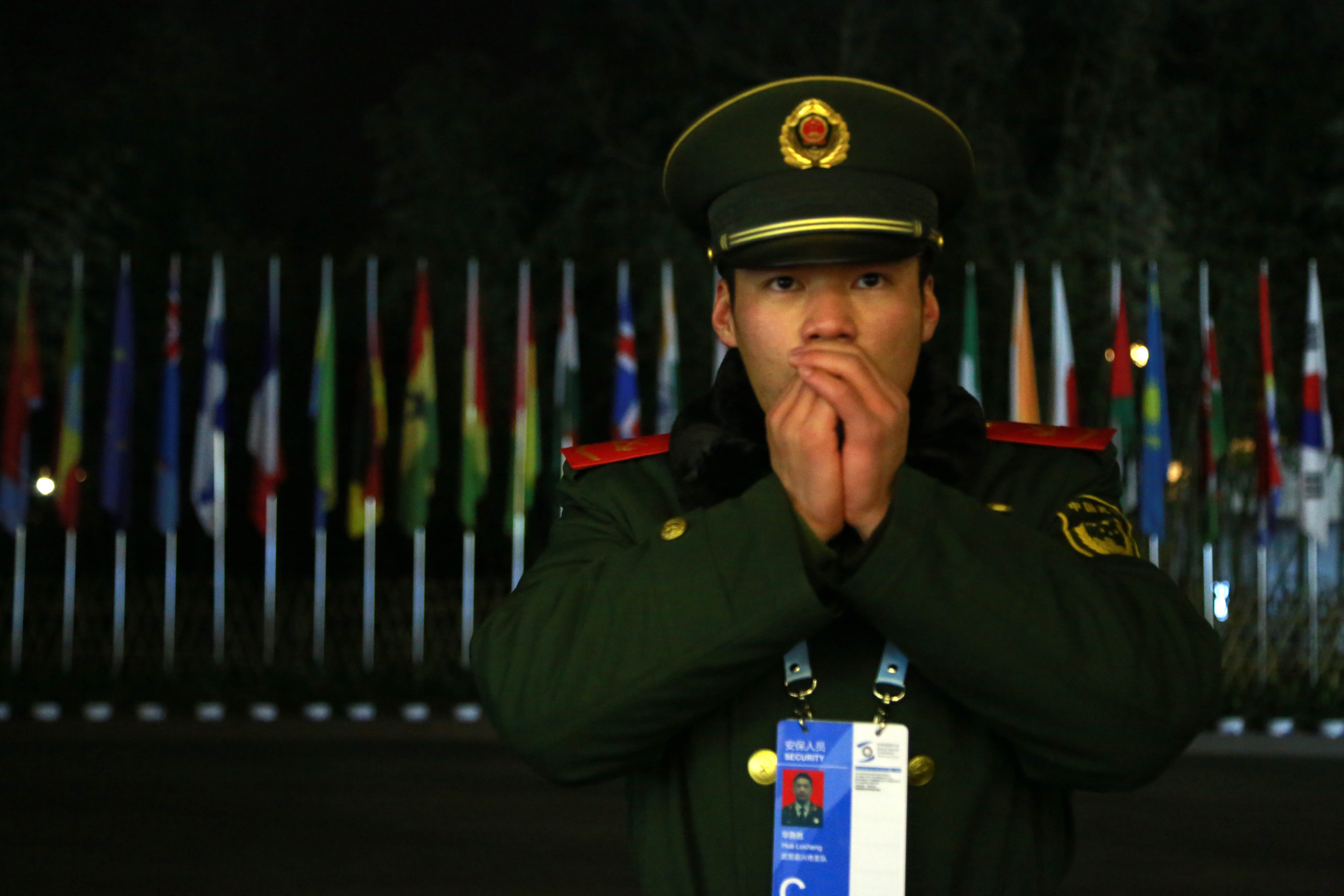 JIAXING, CHINA - DECEMBER 17: (CHINA OUT) An armed police officer exhales to warm himself as he stands guard near the "Light of the Internet" exhibition during the Second World Internet Conference on December 17, 2015 in Jiaxing, Zhejiang Province of Chi