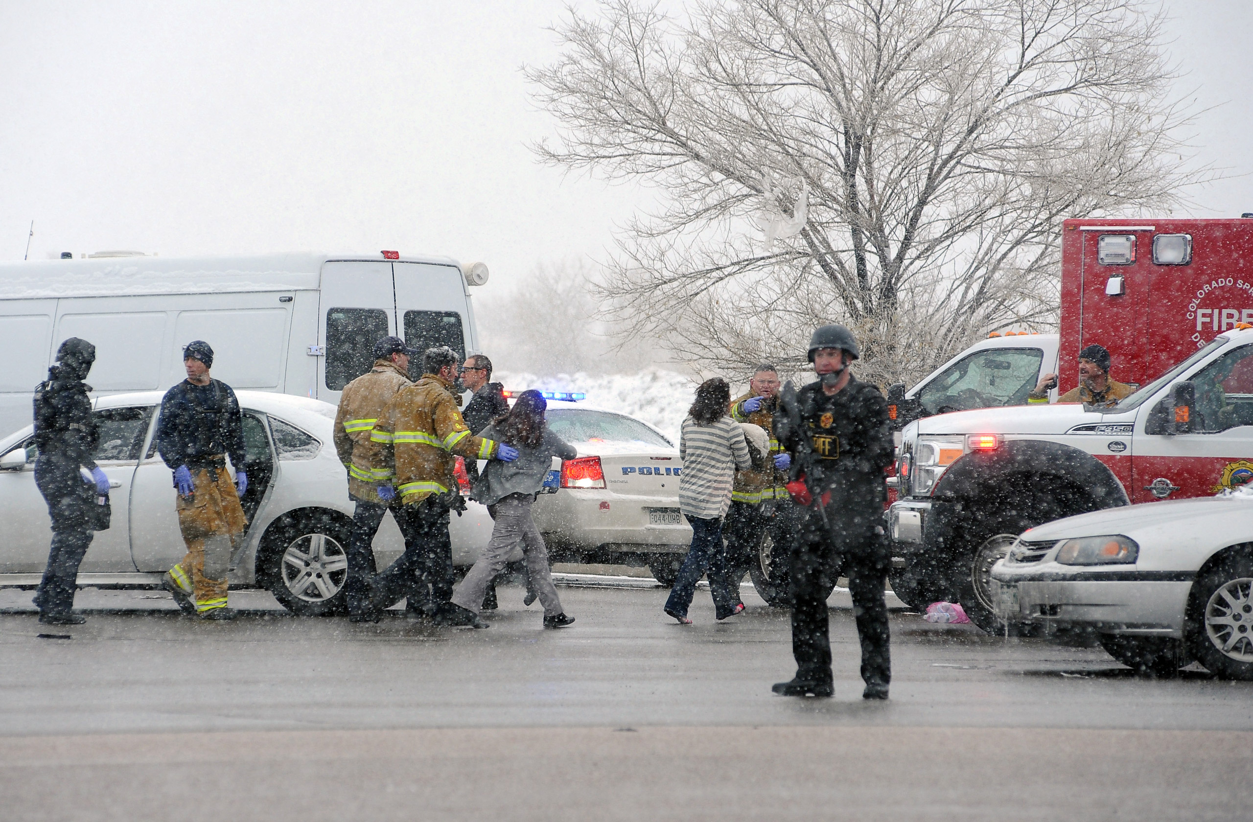 A woman is escorted by emergency personnel after reports of a shooting near the Planned Parenthood clinic Friday, Nov, 27, 2015, in Colorado Springs, Colo. According to authorities multiple injuries have been reported. (Daniel Owen/The Gazette via AP) MA